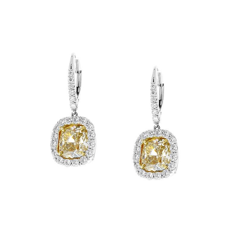 These natural fancy yellow diamond earrings are stunning 6.12 total carats of perfectly matched yellow diamond cushion cuts are the investment. Framed in the sparkle of 1.13 carats of brilliant rounds.
