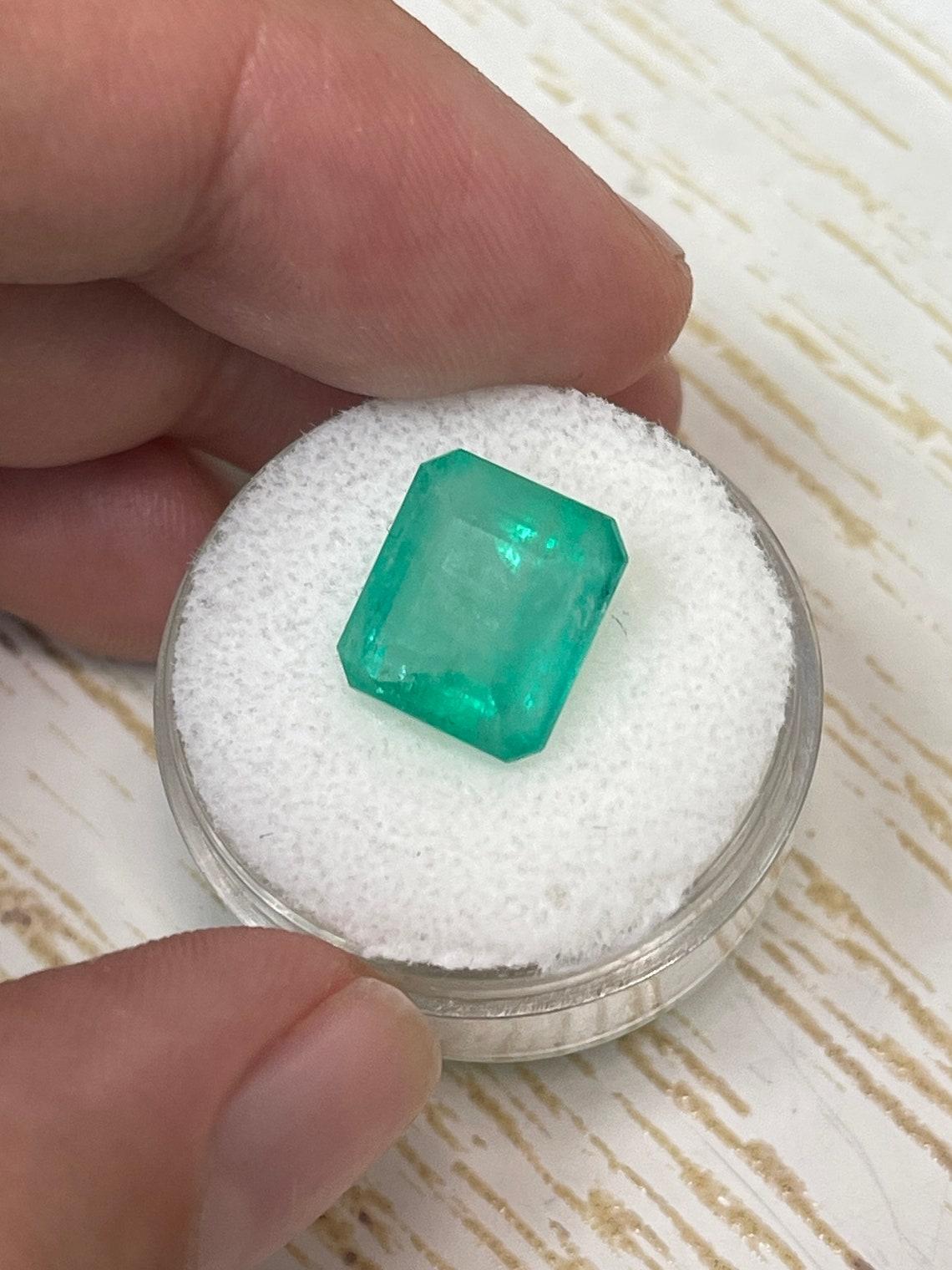 Modern 6.13 Carat 11.5x10.3 Earthy Pastel Green Colombian Emerald - Emerald Cut May For Sale