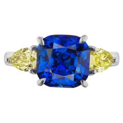 6.13 Carat Blue Sapphire and Yellow Diamond Three-Stone Ring in Platinum