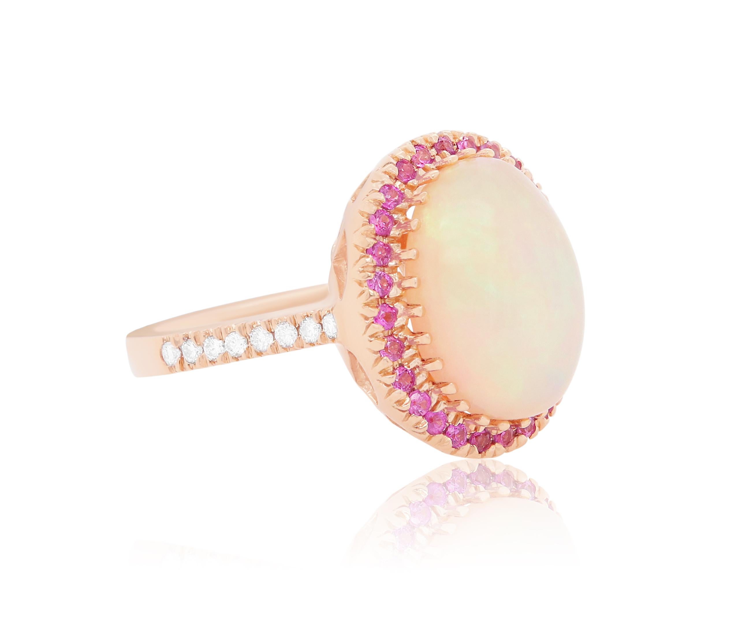 Material: 14k Yellow Gold 
Center Stone Detail:  1 Oval Opal at 6.13 Carats - Measuring 15.4 x 11.7 mm
Mounting Stone Details:  28 Round Pink Sapphires at 0.45 Carats
Diamond Details: 16 Brilliant Round White Diamonds at 0.20 Carats - Clarity: SI /