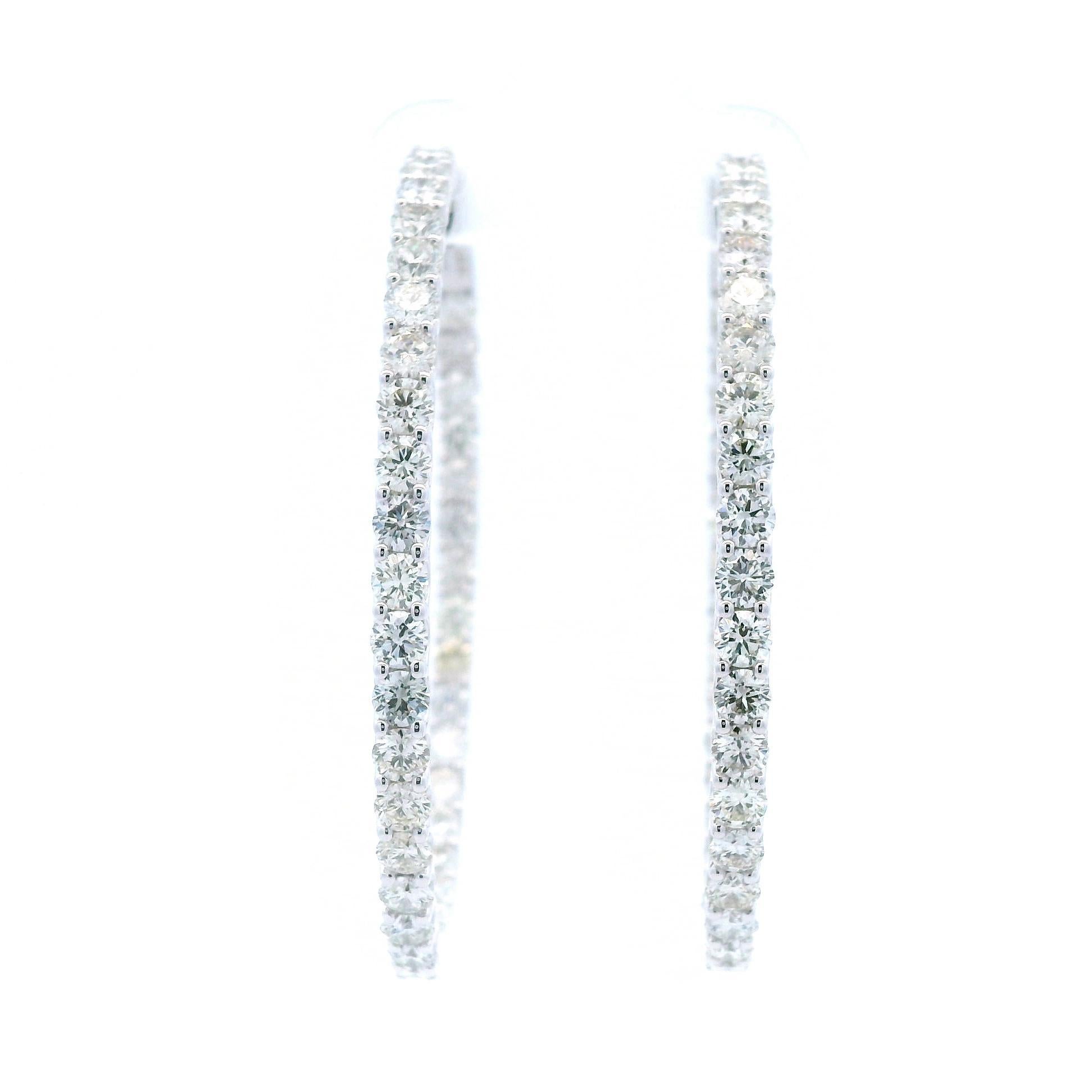 Classic natural round diamond hoop earrings.
72 round brilliant diamonds, 6.13 carats total. Approximately I color and VS1 clarity. Four prong set 14k white gold, 11.63 grams.
Accommodated with an up to date digital appraisal by a GIA G.G., once