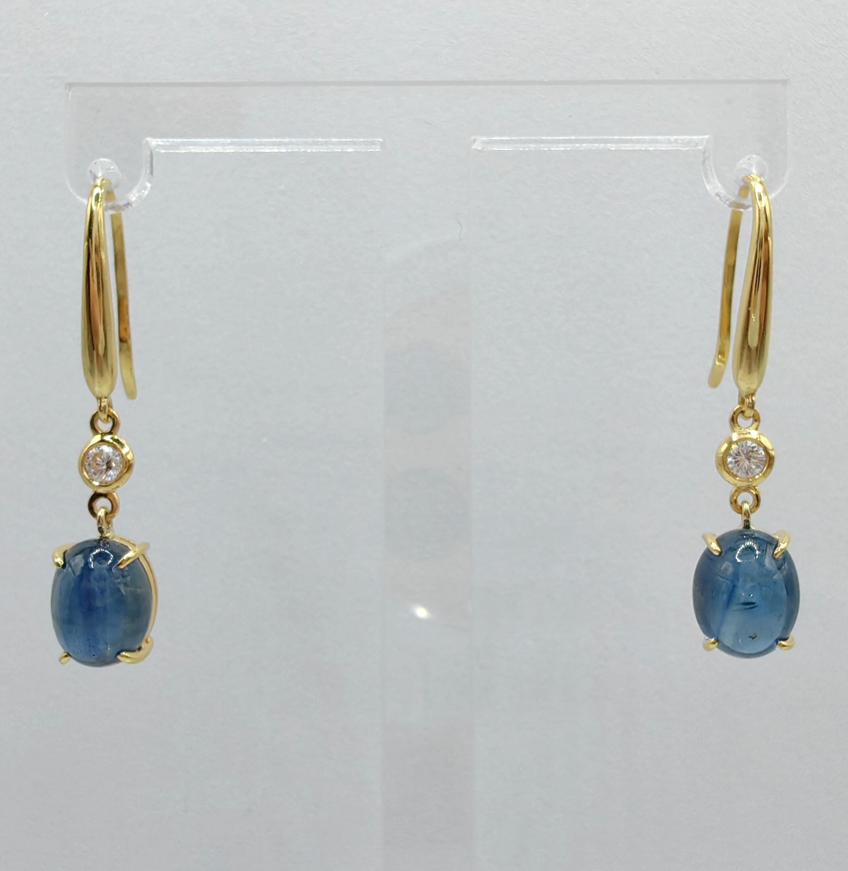 Introducing our exquisite 6.13ct Cabochon Blue Sapphire Diamond Dangling Earrings, where the captivating beauty of blue sapphires and brilliant diamonds takes center stage. 

At the heart of these earrings are two mesmerizing cabochon blue