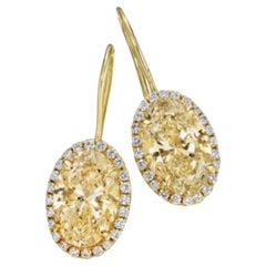 6.13ct GIA Certified Oval Yellow Diamond Earrings in 18KT Gold