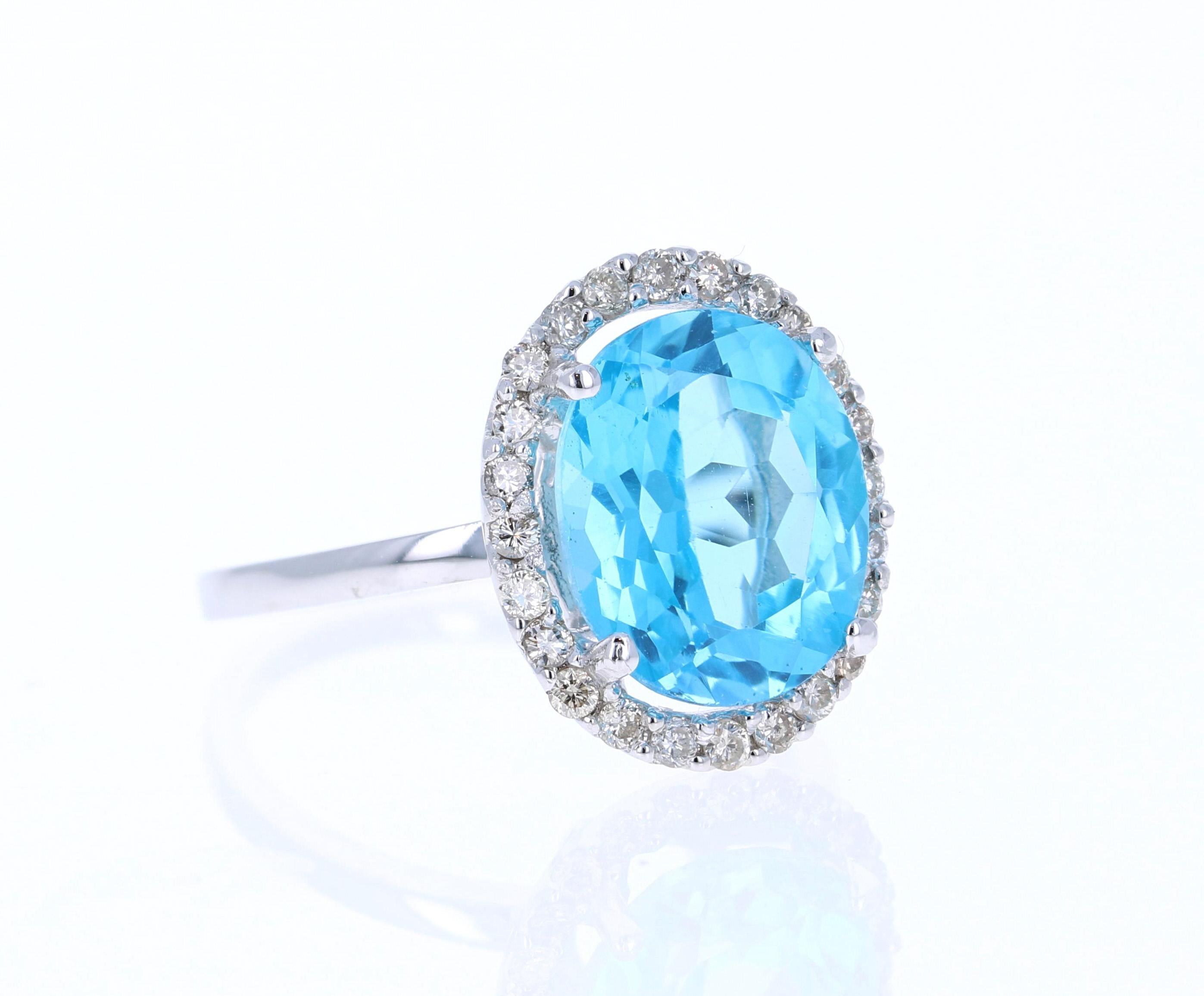 This Oval Cut Blue Topaz Diamond ring has a 5.77 Carat Blue Topaz and is surrounded by 24 Round Cut Diamonds that weigh 0.37 Carats. The total carat weight of the ring is 6.14 Carats. 

The setting is crafted in 14K White Gold and weighs 3.2 grams.
