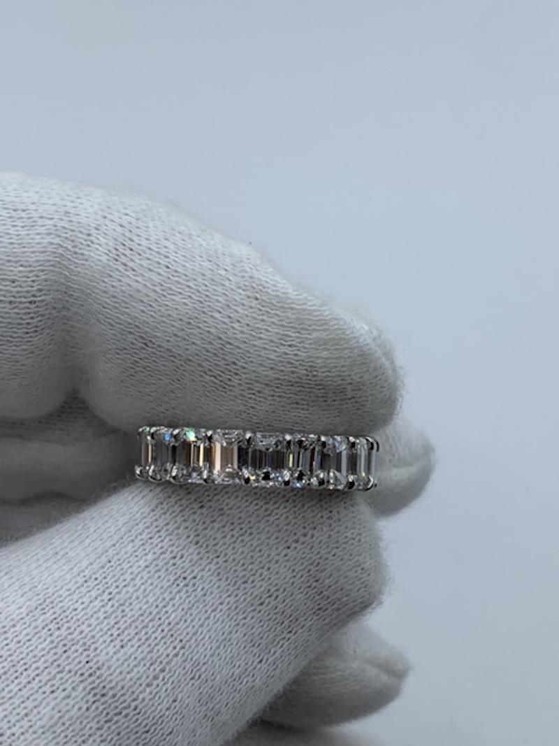 Classic Emerald Cut Diamond Eternity Band featuring 19 Stones weighing a Total of 6.14 Carats. Average is 32 Points each.
Diamonds are of F color and VS Clarity.
Set in Platinum.
Size 4.5
Pictured stacked between 2 Round Bands.