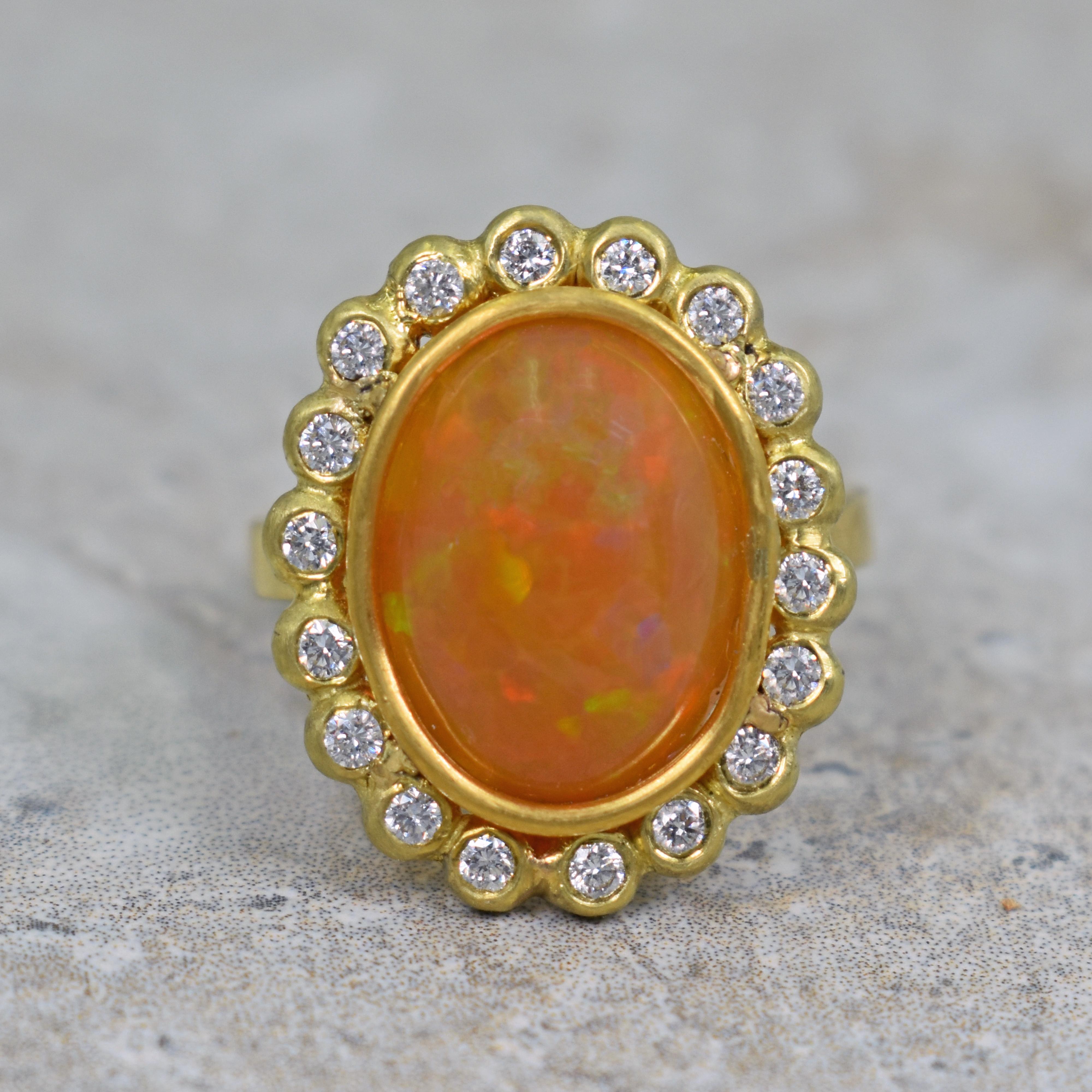 6.14 carat oval Ethiopian Opal set in a hand fabricated 22k yellow gold and diamond halo ring. Halo has 18 diamonds (0.36 total carat weight, G-H, SI1). Size 6 1/2. One-of-a-kind artisan ring with a fiery opal gemstone. 