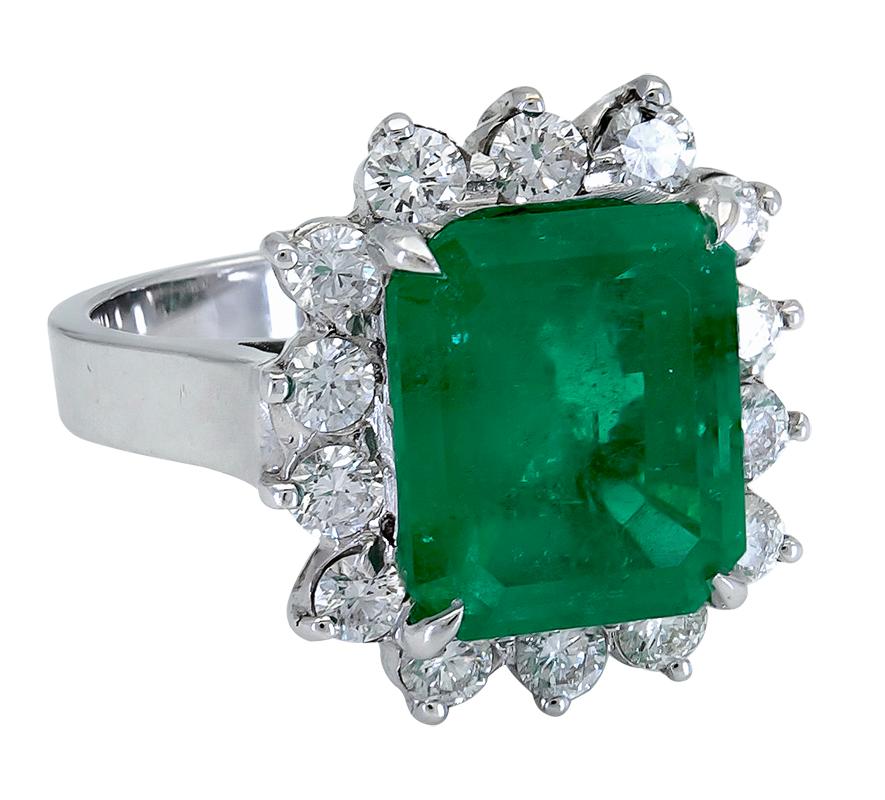Features an emerald cut green emerald, accented with brilliant diamonds set in a floral motif. Made in A magnificent piece of jewelry.
Green emerald weighs 6.15 carats.
Diamonds weigh 0.95 carats total.
Size 6.75 US (sizable)
Dimensions: 0.71 in x