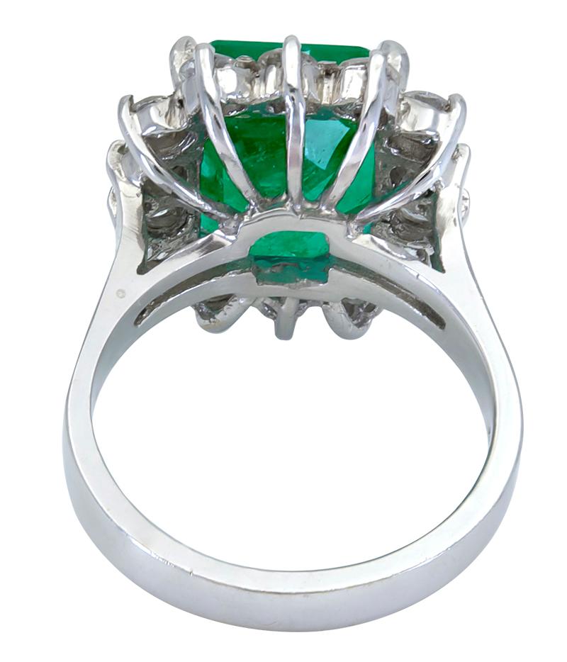 green emerald halo engagement ring