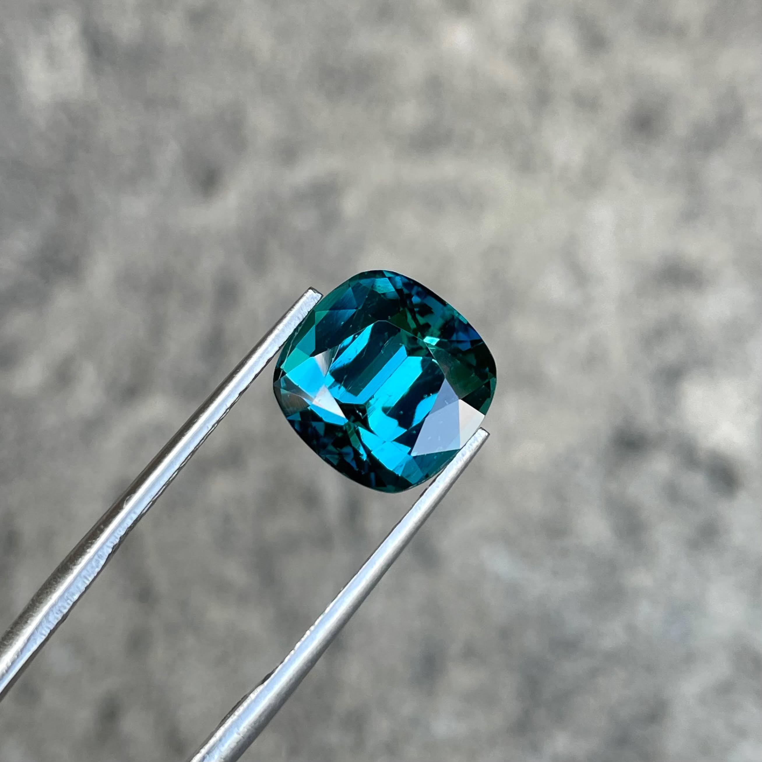 Weight 6.15 carats 
Dimensions 10.6x10.7x7.51 mm
Treatment None
Clarity Eye Clean
Origin Afghanistan
Shape Cushion
Cut Step Cushion




The captivating allure of a 6.15 carat Lagoon Blue Tourmaline takes center stage, showcasing its exquisite beauty