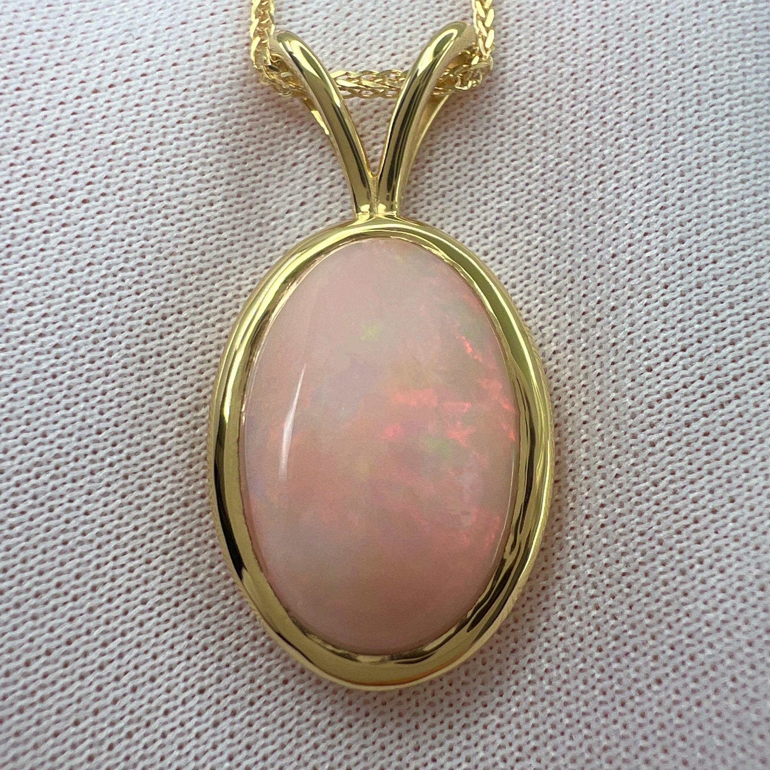 Fine White Opal 18 Karat Yellow Gold Pendant Necklace.

6.15 Carat opal with beautiful play of colour and an excellent oval cabochon cut. Set in a fine 18k yellow gold rubover bezel solitaire pendant. 
Stunning solid opal with an excellent polish