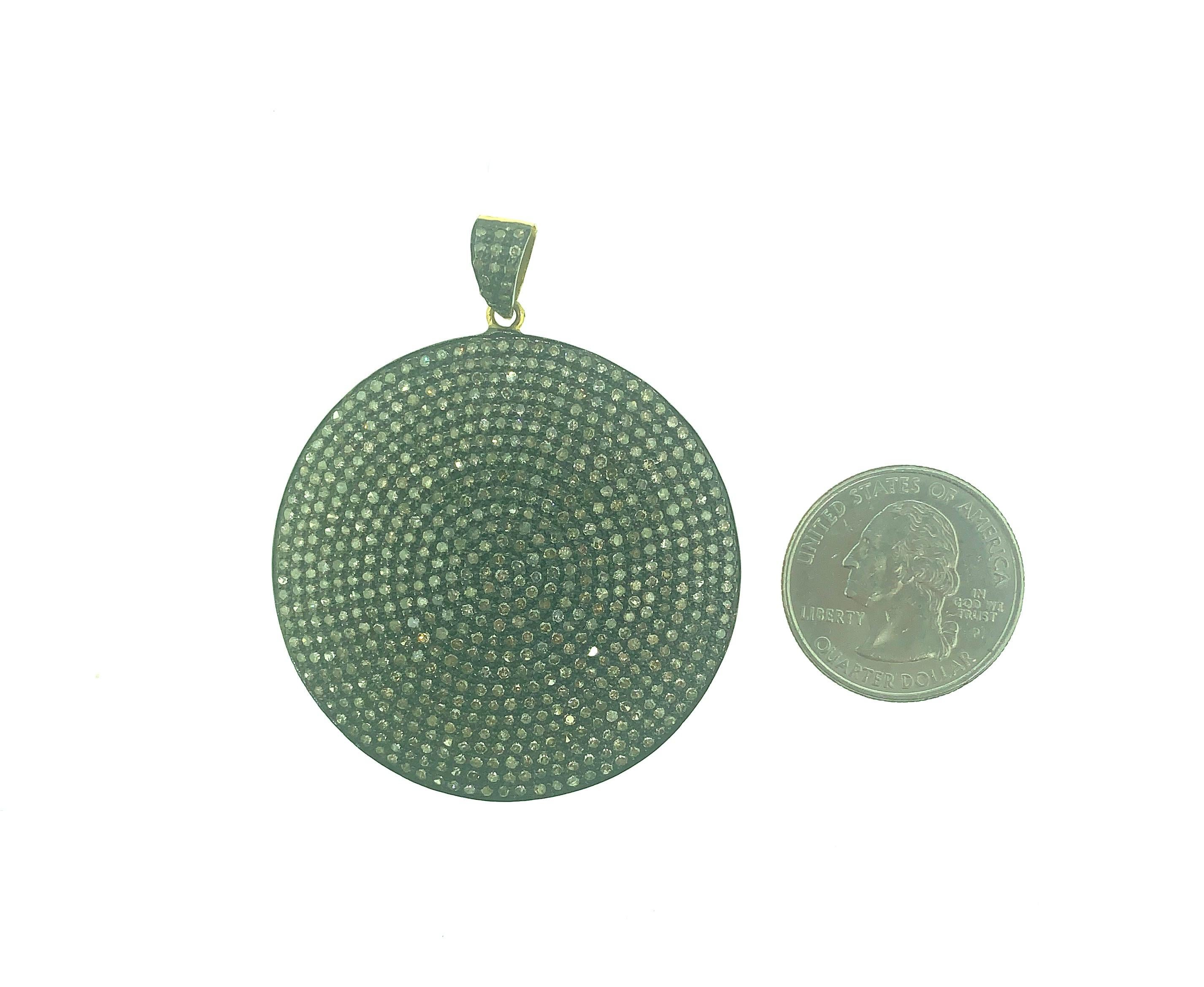 6.15 ct Round Pave Champagne Diamond Disc Pendant set in Oxidized Sterling Silver back of bail in 14KT Gold. This 2.5 Inch long (including bail) is made in India. 
Diamonds - 6.15 ct Champagne Diamonds
Dimension : 2.5 Inch (Including Bail)
Gross