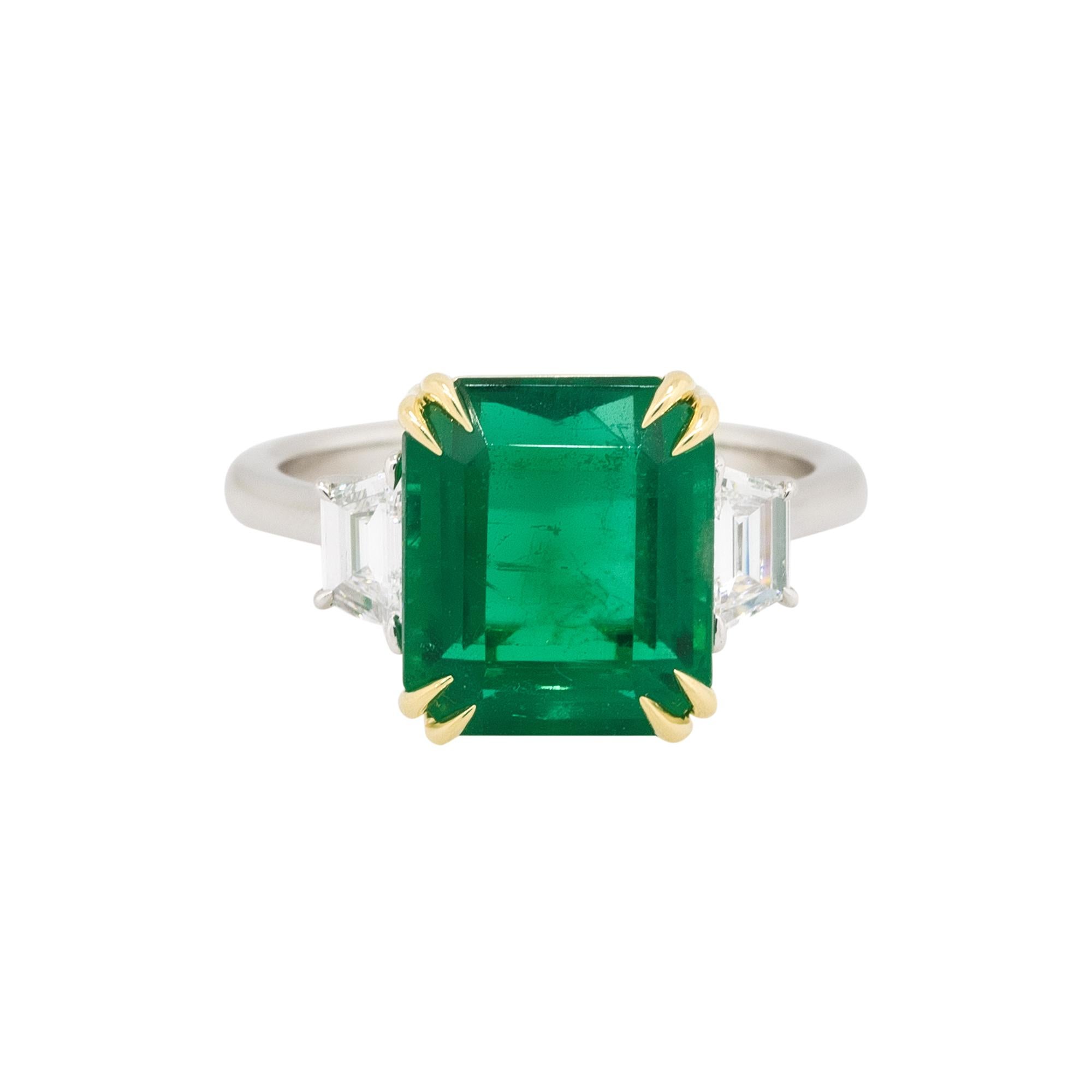 Material: Platinum & 18k yellow gold
Diamond Details: Approx. 48ctw of trapezoid shaped Diamonds. Diamonds are G/H in color and VS in clarity
Gemstone Details: Approx. 6.16ctw Emerald center gemstone
Ring Size: 6
Total Weight: 7.1g