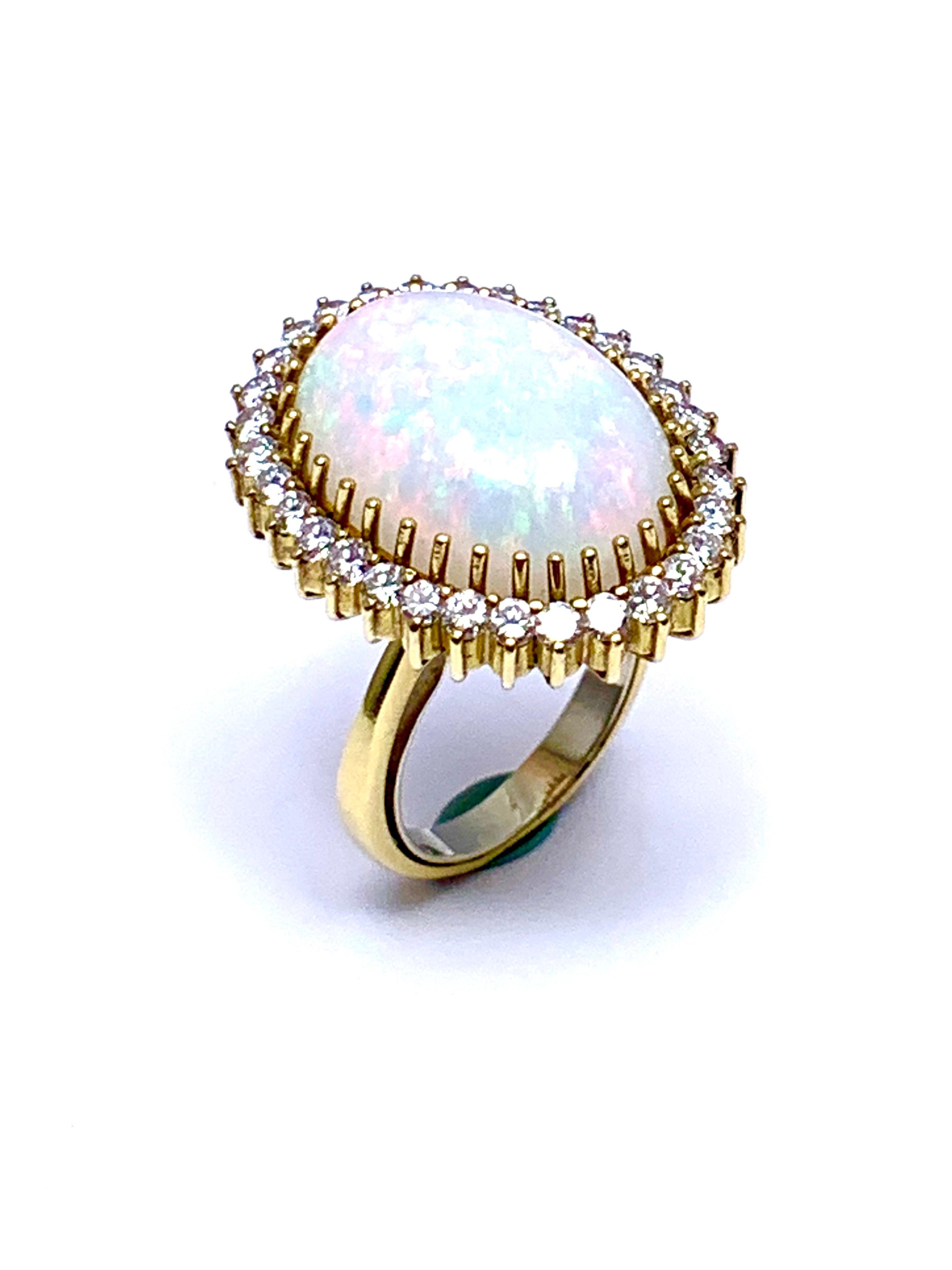 A beautiful oval cabochon White Opal and round brilliant Diamond cocktail ring.  The 6.16 carat Opal is prong set with a single row of diamonds surrounding,  The diamonds are graded as G color, VS clarity, combining for a total weight of 0.30