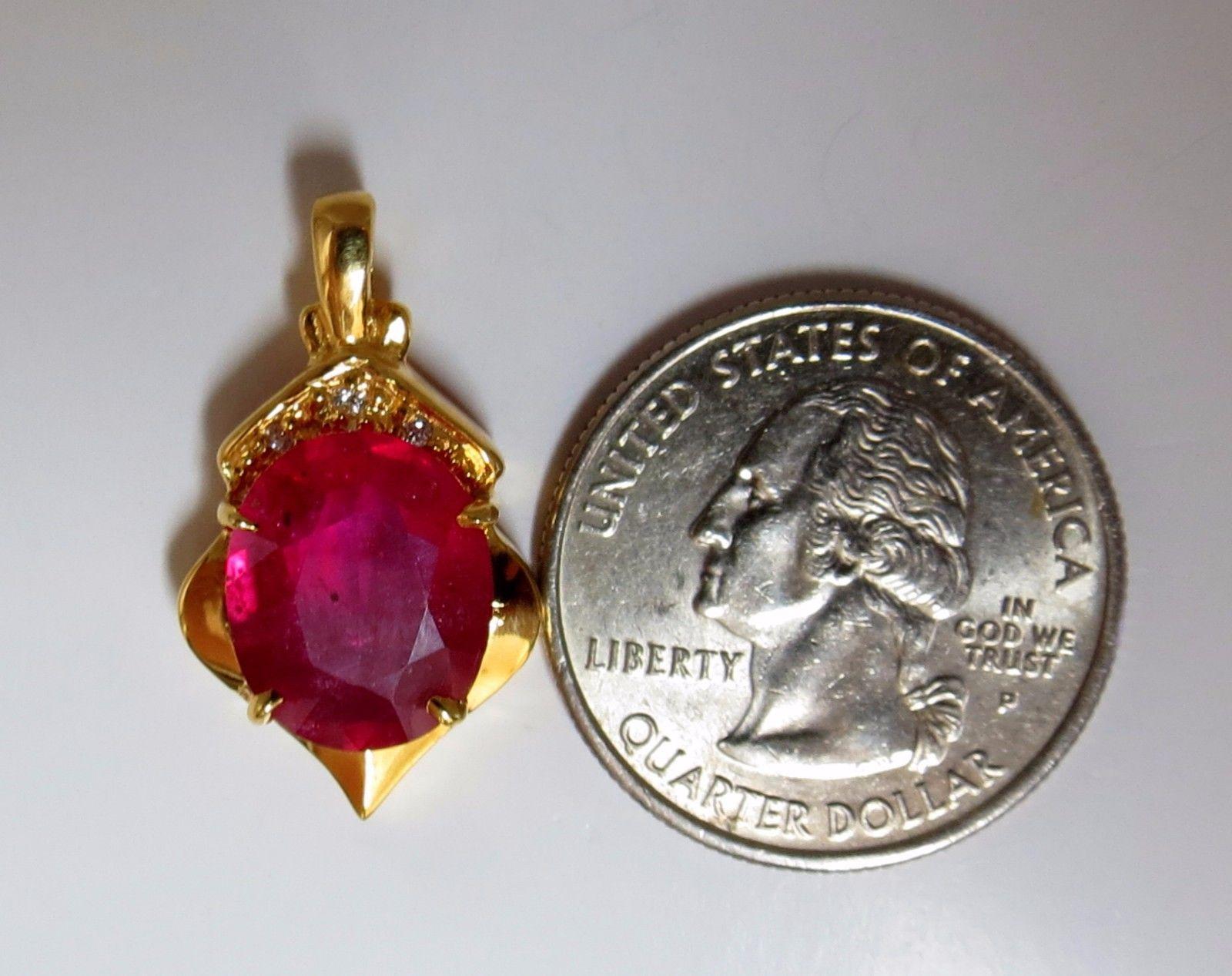 6.10ct Natural oval brilliant full cut ruby pendant.

Clean Clarity, transparent.

Glass filling.

Vivid Red.

12 X 11mm

.06ct. Natural diamonds

 Si-1  clarity / H-color

Rounds, Full cuts.

14kt yellow gold 

4.1 grams.

Pendant: .79 X