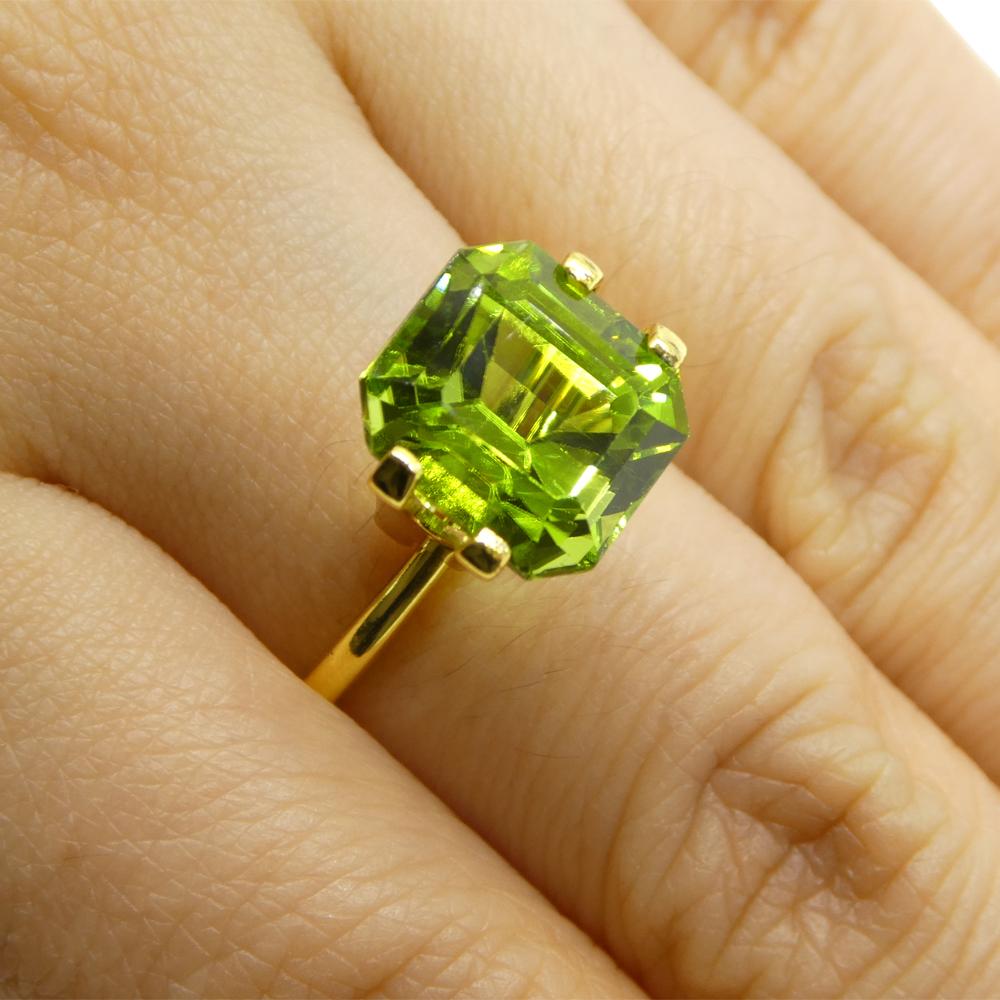 Description:

Gem Type: Peridot
Number of Stones: 1
Weight: 6.16 cts
Measurements: 10.45 x 9.63 x 7.51 mm
Shape: Emerald Cut
Cutting Style Crown: Step Cut
Cutting Style Pavilion: Step Cut
Transparency: Transparent
Clarity: Very Slightly Included:
