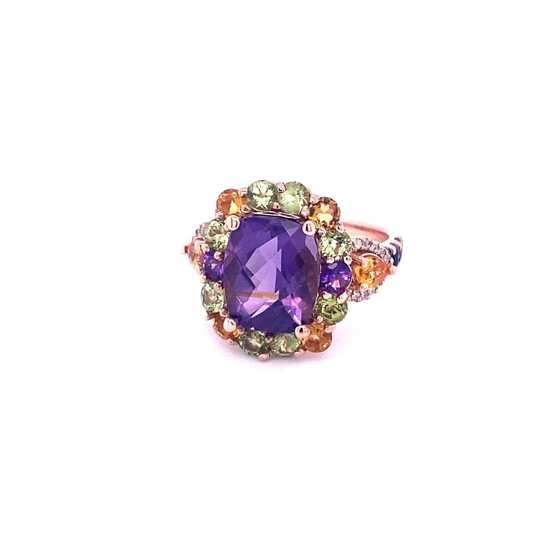 This ring has a beautiful dark purple Cushion Cut Amethyst that weighs 3.77 Carats in the center of the ring and is embellished with 20 Amethysts, Peridots and Yellow Topaz that weigh 1.91 Carats.  
The shank of the ring is accented with 2 Pear Cut