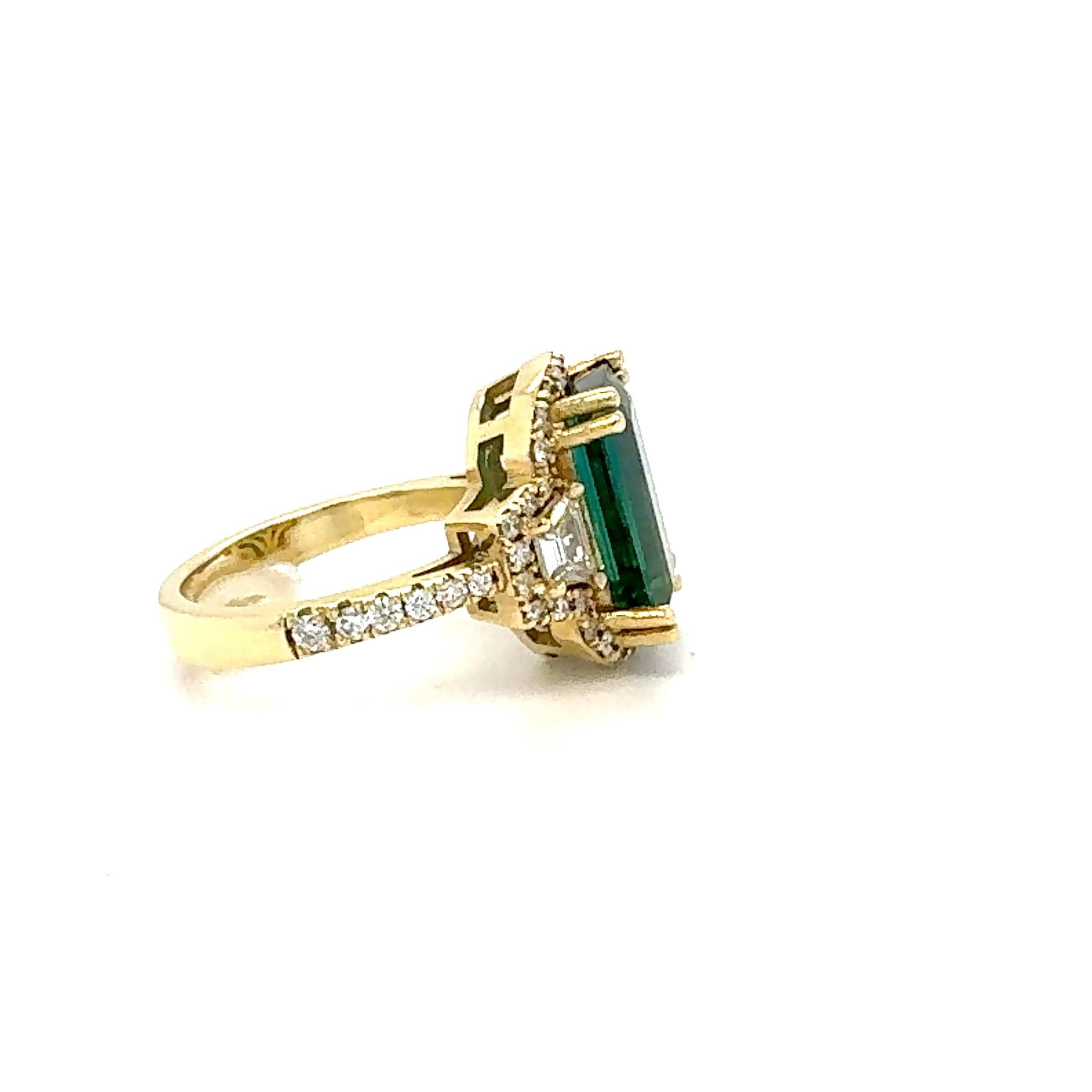 6.17 Carat Green Tourmaline Diamond 18 Karat Yellow Gold Three-Stone Ring

This gorgeous and unique 3-stone ring has a beautiful Emerald cut Green Tourmaline weighing 5.21 carats and is surrounded by a halo of 44 Round Cut Diamonds weighing 0.52