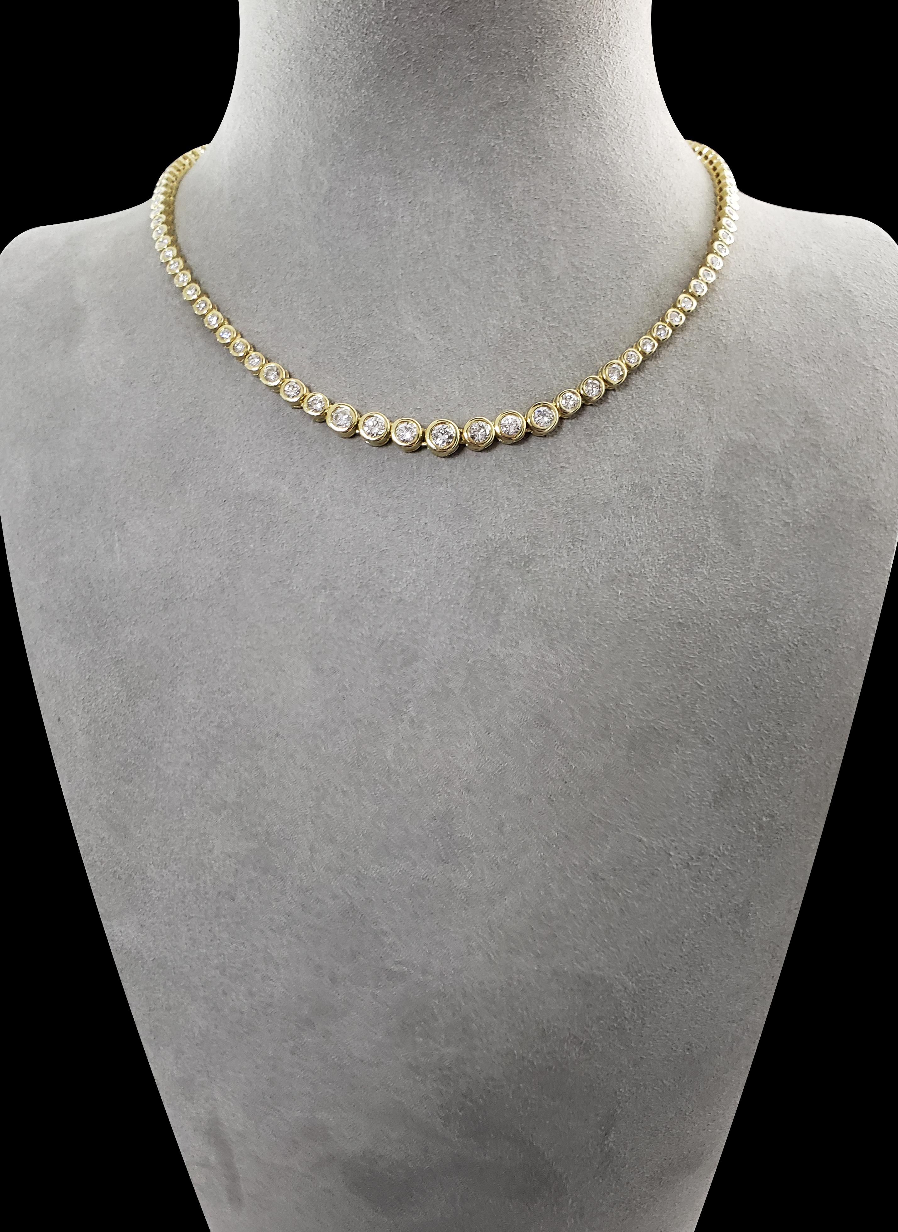 A versatile necklace for casual, everyday wear or to compliment a formal style. Showcases brilliant round diamonds set in a 14 karat yellow gold bezel. Each diamond graduates larger as it drops to center. Diamonds weigh 6.17 carats total. 16 inches
