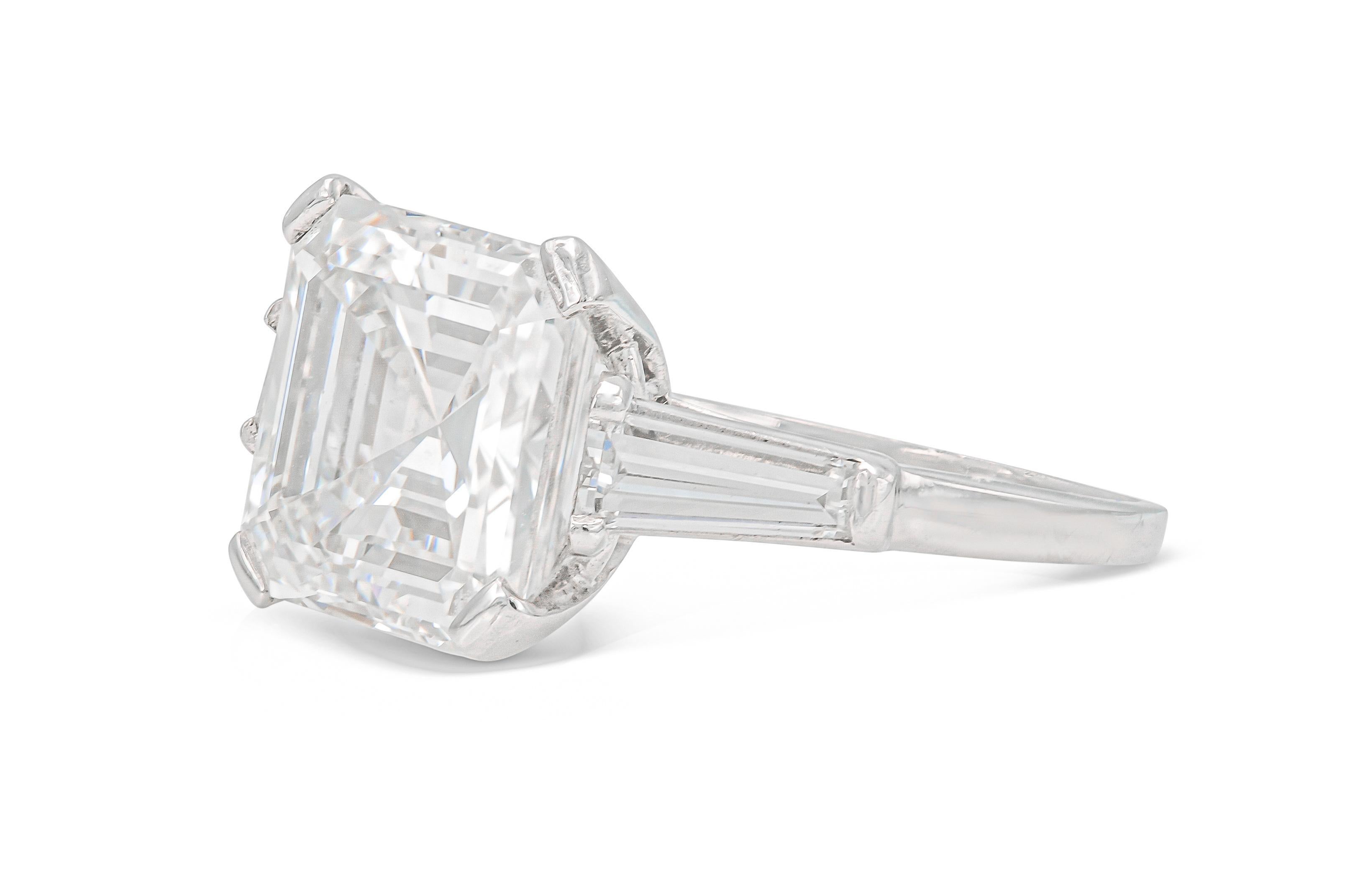 Finely crafted in platinum with a GIA certified Square Emerald cut Diamond weighing 6.17 carats, I color, VS1 clarity, GIA #6183093648.
The ring features 2 accenting Tapered Baguette cut Diamonds weighing a total of approximately 0.80 carat.
Size 6