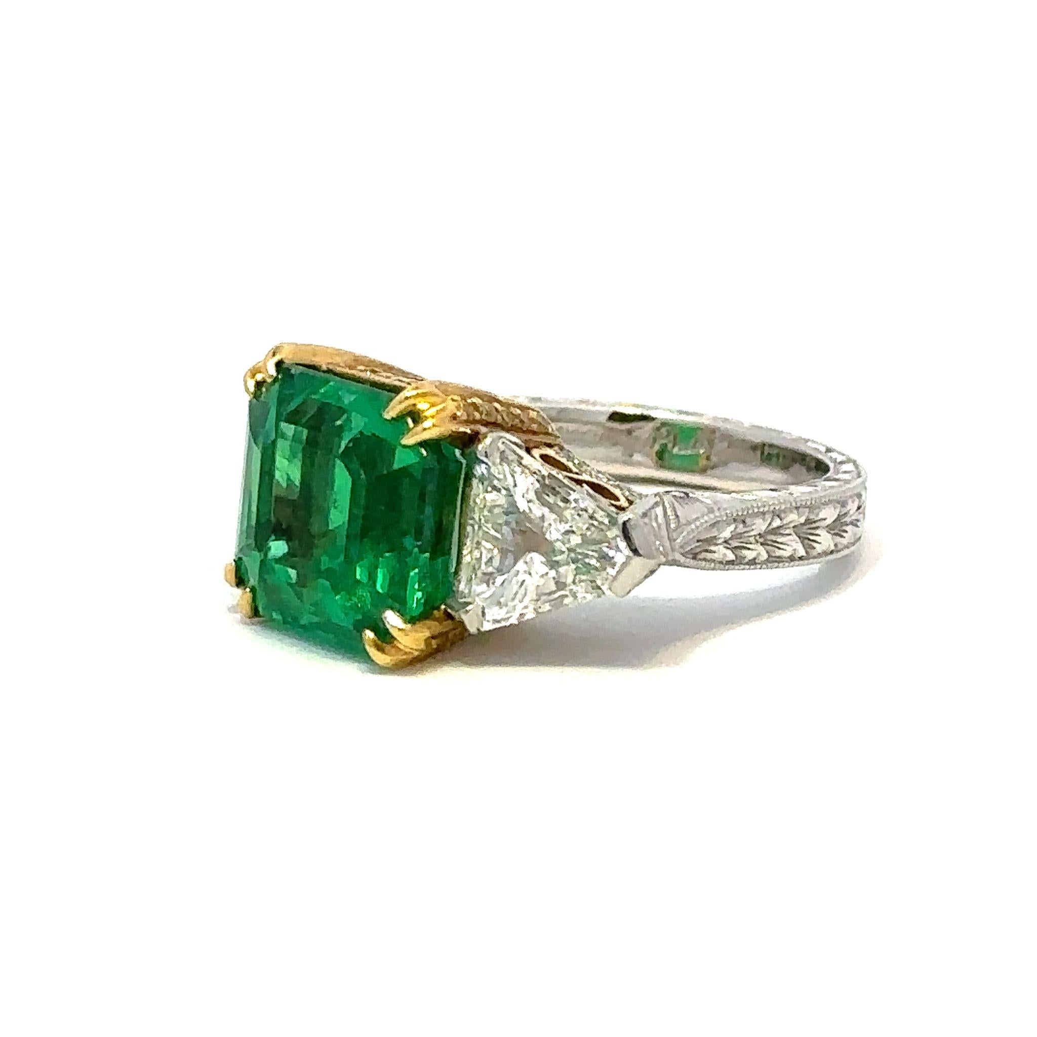 Platinum and 18K yellow gold ring showcasing a 6.18 carat natural Columbian emerald-cut emerald accented by trillion-cut diamonds and natural fancy yellow diamonds.  The emerald is accompanied by both AGL and AGTA reports.  The diamonds total 1.78