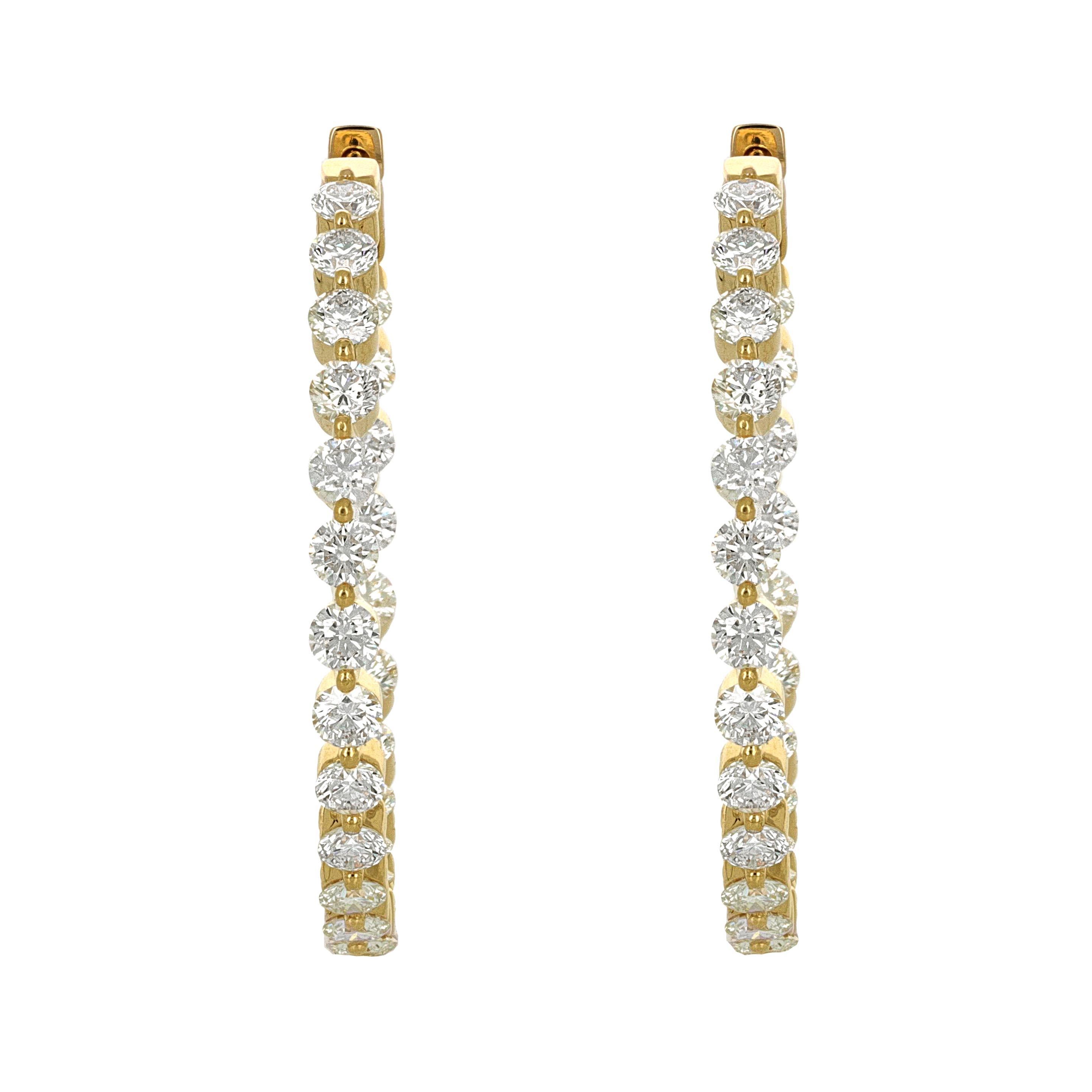 18 karat yellow gold diamond hoop earrings. There are 48 round brilliant diamonds weighing a total carat weight of 6.18 carats. The diamonds are H/I color, VS/SI clarity.

