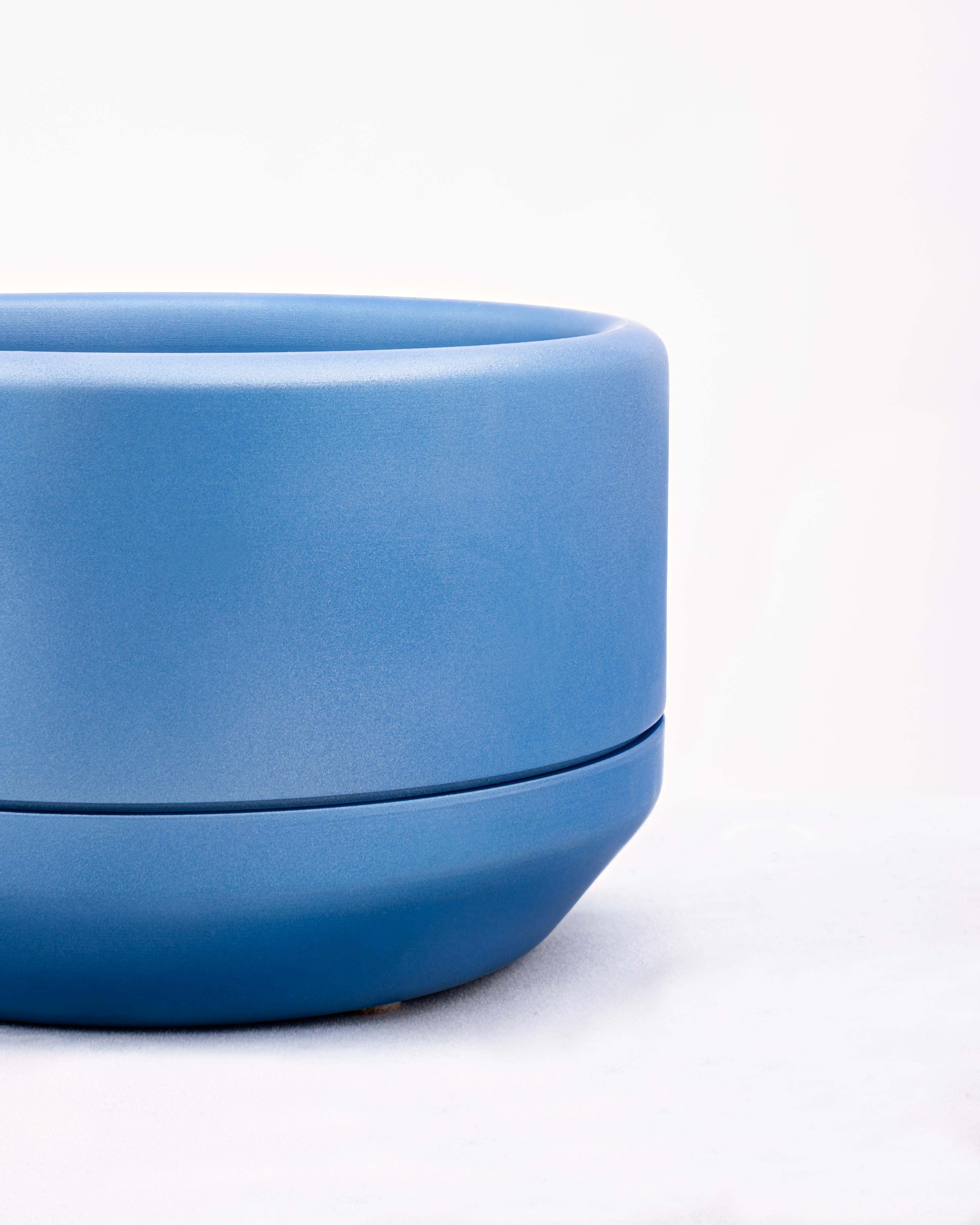 CNC milled and spun aluminum planter with blue ceramic coat finish. The main body of the planter is set on a loose spun aluminum drainage base. Interior dimensions are 5.5 inches diameter, and 2.75