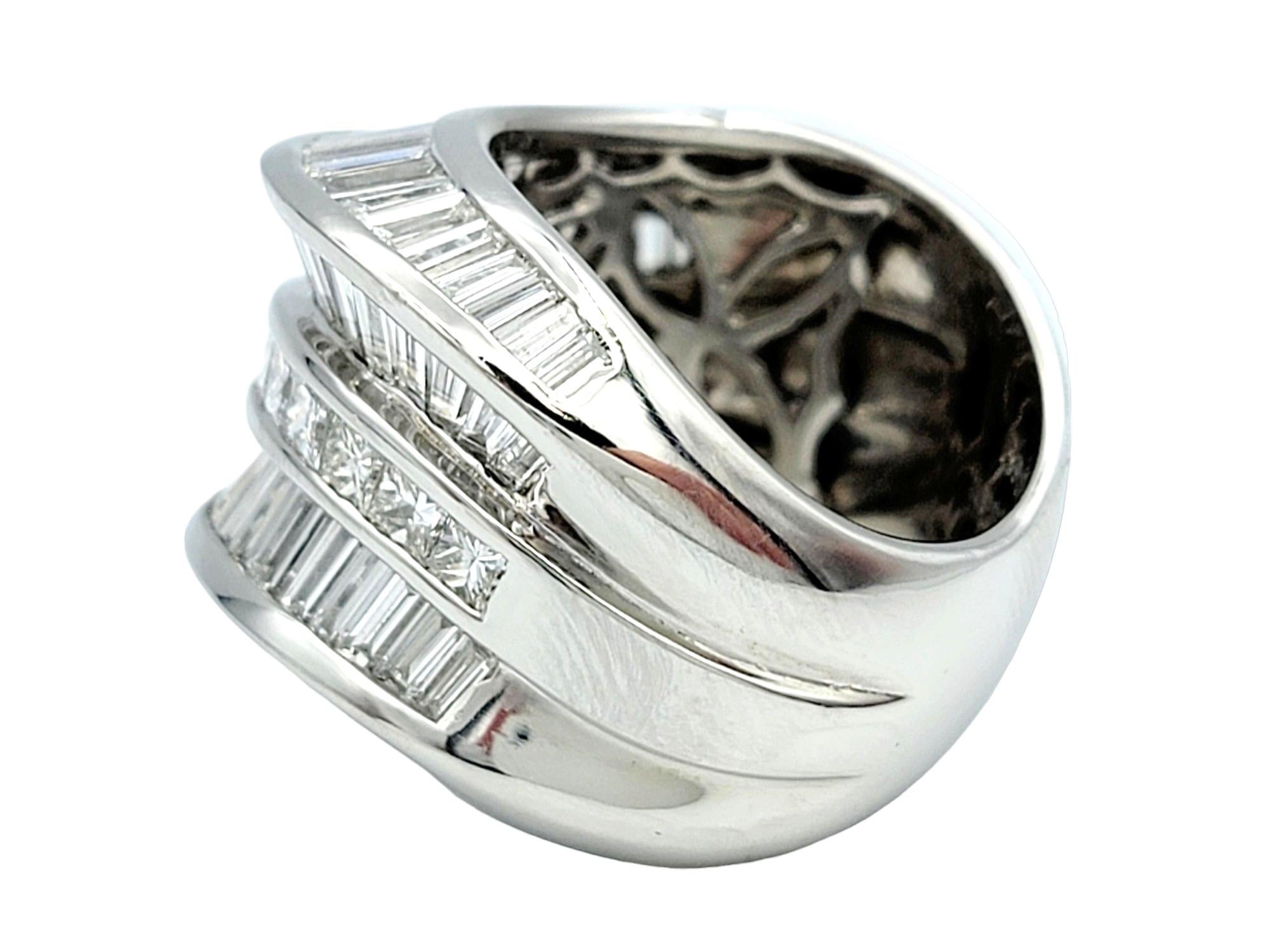 Ring Size: 6.5

This gorgeous wide band ring, with its unique combination of baguette and princess cut diamonds, is a striking work of art. The use of polished platinum ensures not only a luxurious appearance but also durability and longevity. The