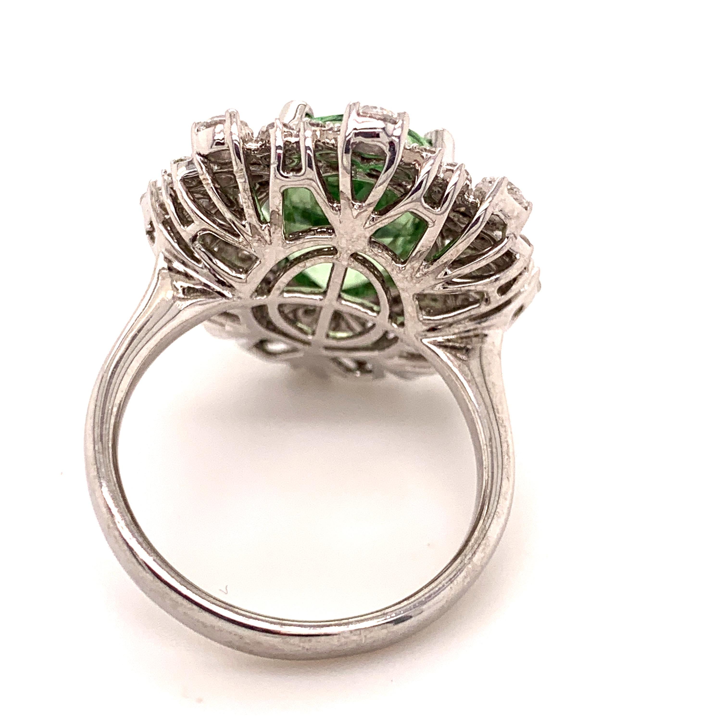 This 18-karat white gold ring size 6 1/2 has a cluster of 64 Diamonds in various sizes and shapes with G color and VS Grade weighing a total of 1.64 carats. The mint green center stone is a Merelani Mint Garnet (verity Grossular Garnet)  and as the