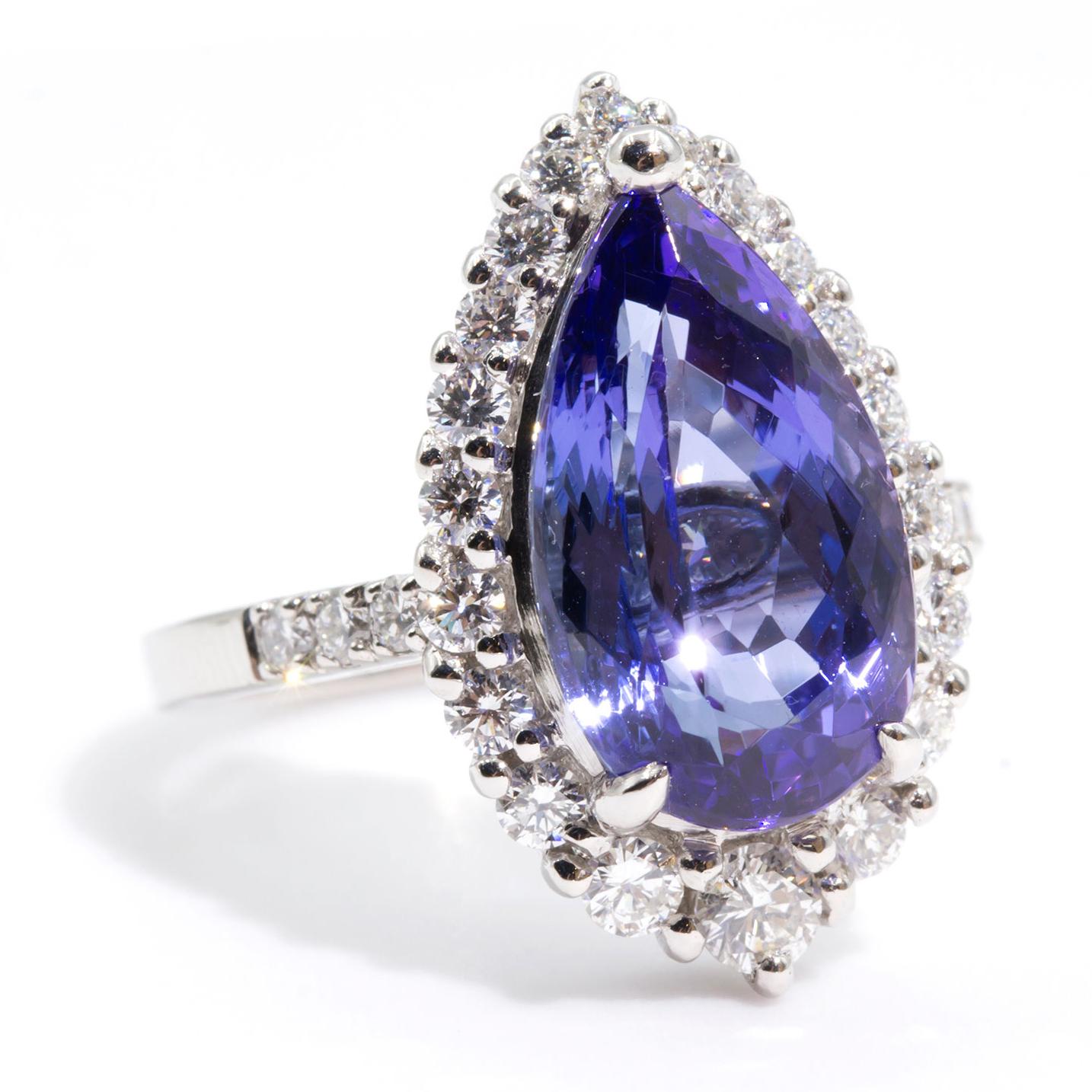 Forged in Platinum is this unique halo cluster ring featuring a mesmerising pear shape 6.19 carat tanzanite, encompassed by 0.78 carats of sparkling round brilliant cut diamonds. There is a secret diamond set under the setting making this ring even