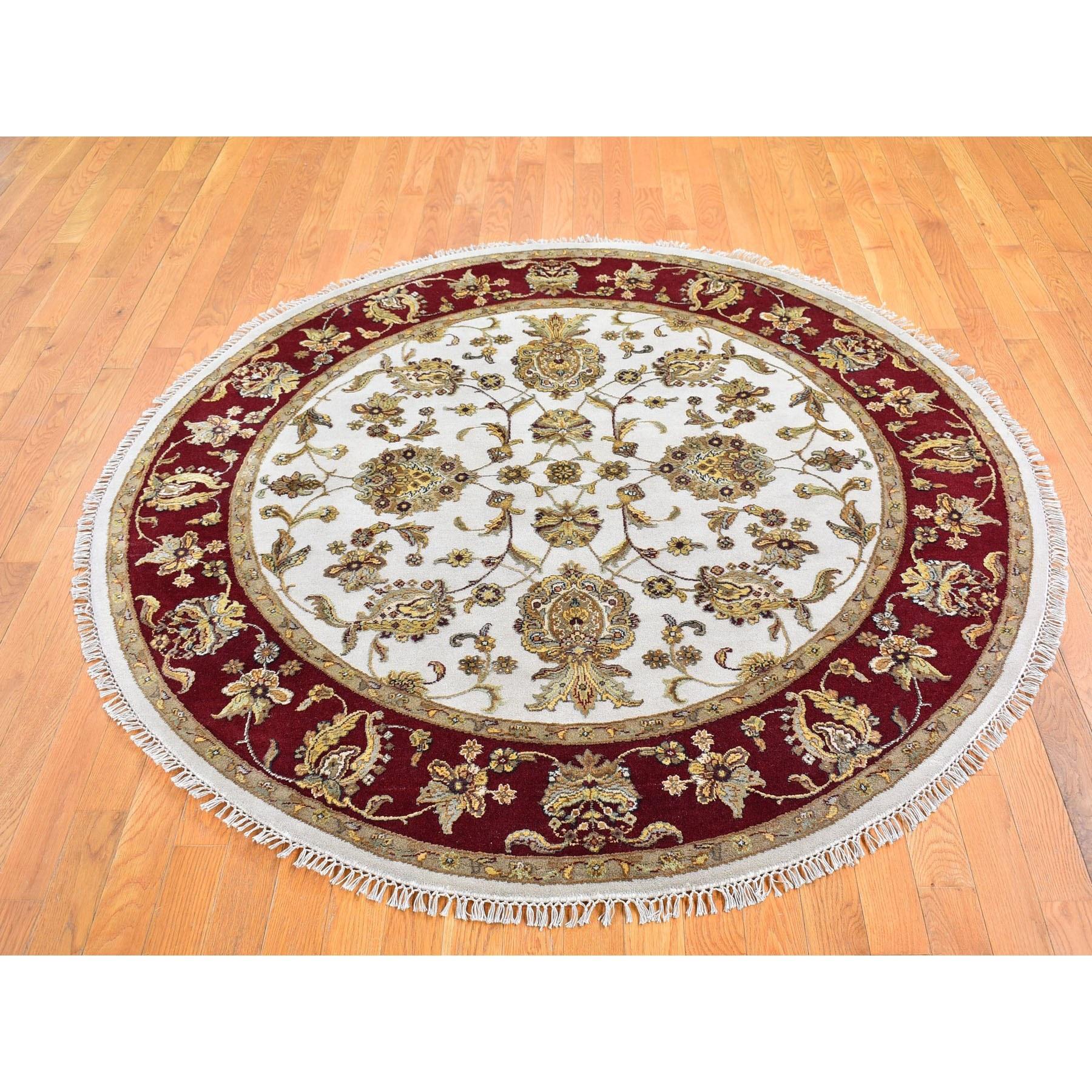 This is a truly genuine one-of-a-kind Ivory Rajasthan Half Wool and Half Silk Floral Design Thick and Plush Hand Knotted Round Oriental Rug. It has been woven for months and months in the centuries-old Persian weaving craftsmanship techniques by