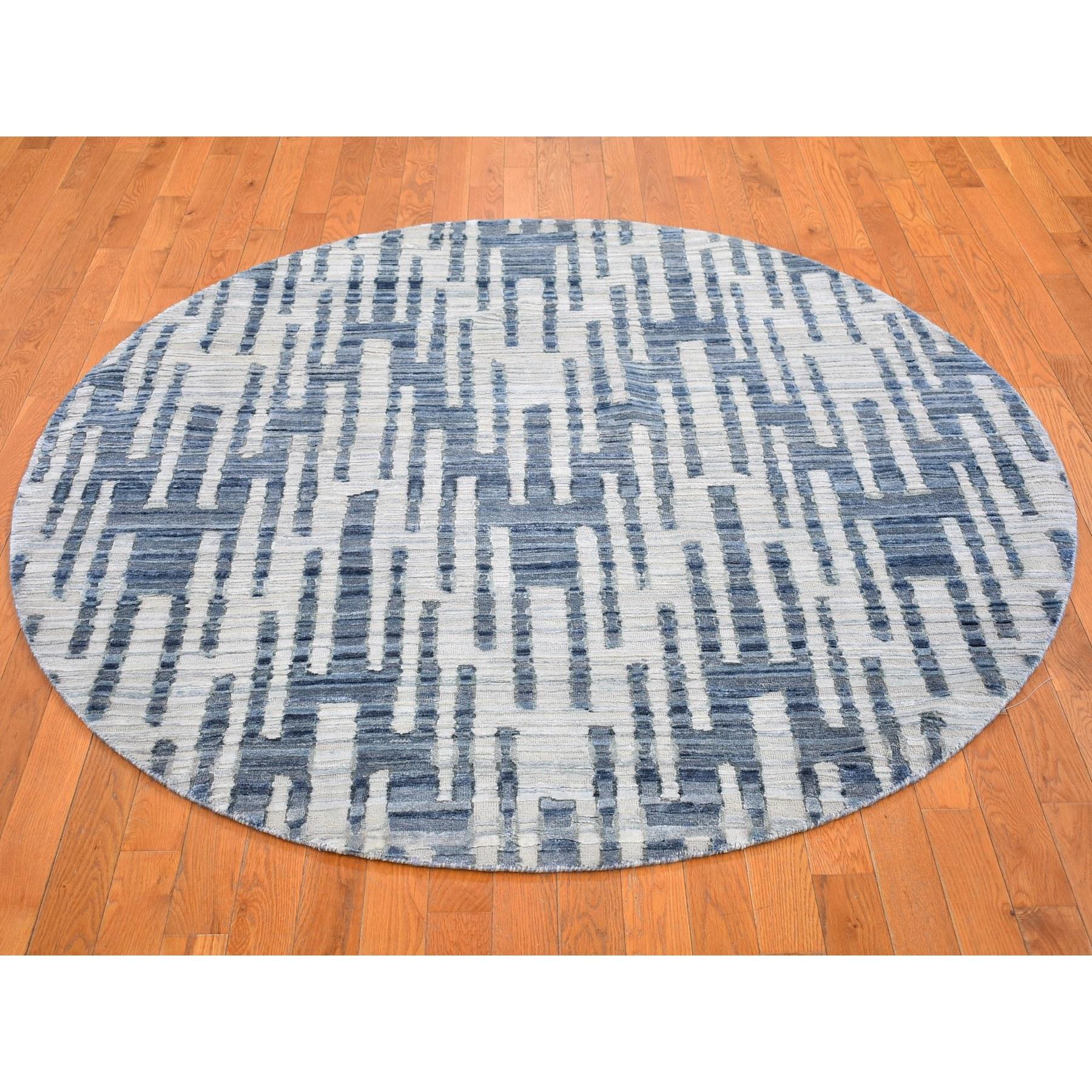 This is a truly genuine one-of-a-kind Blue Pure Silk and Textured Wool Zigzag with Graph Design Hand Knotted Round Oriental Rug. It has been woven for months and months in the centuries-old Persian weaving craftsmanship techniques by expert