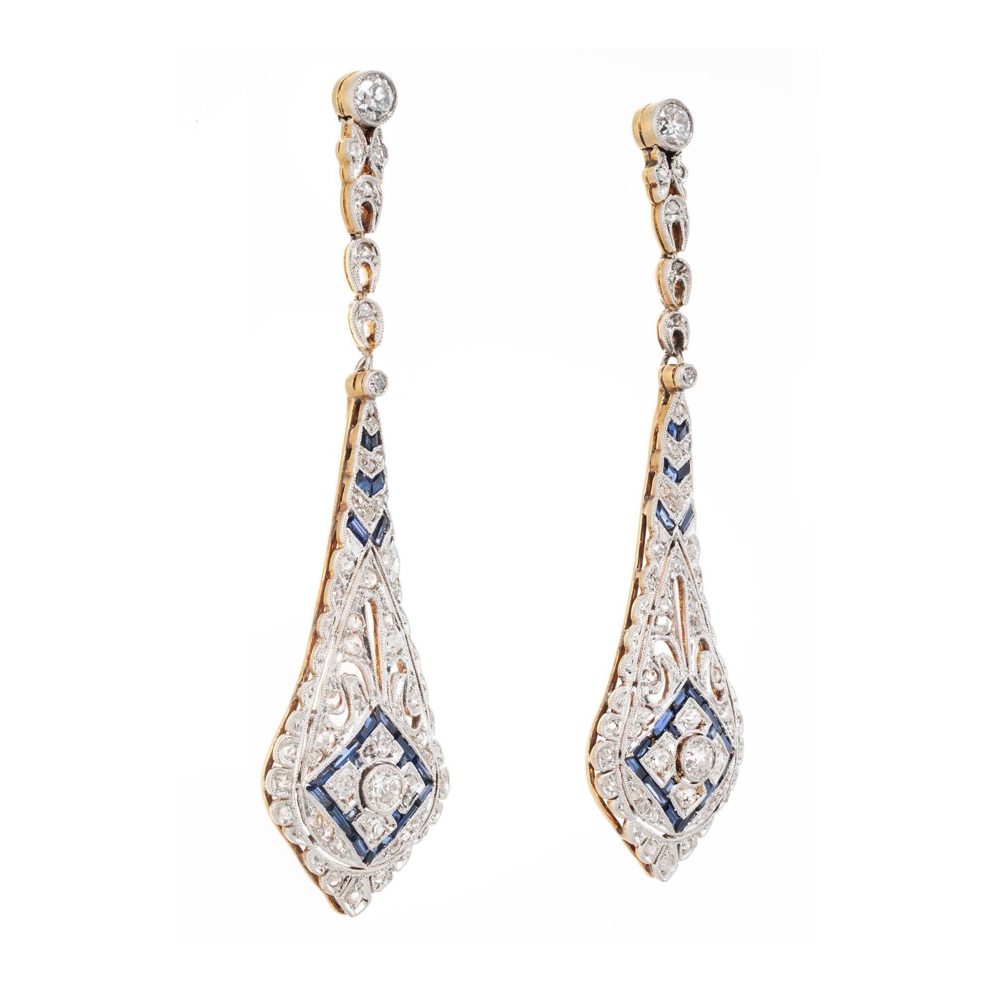 Vintage turn of the century diamond and sapphire dangle drop earrings. These vintage antique earrings were created in the late 1890s early 1900's. Handmade with a cluster of old European, rose cut diamonds and baguette sapphires. The incredible