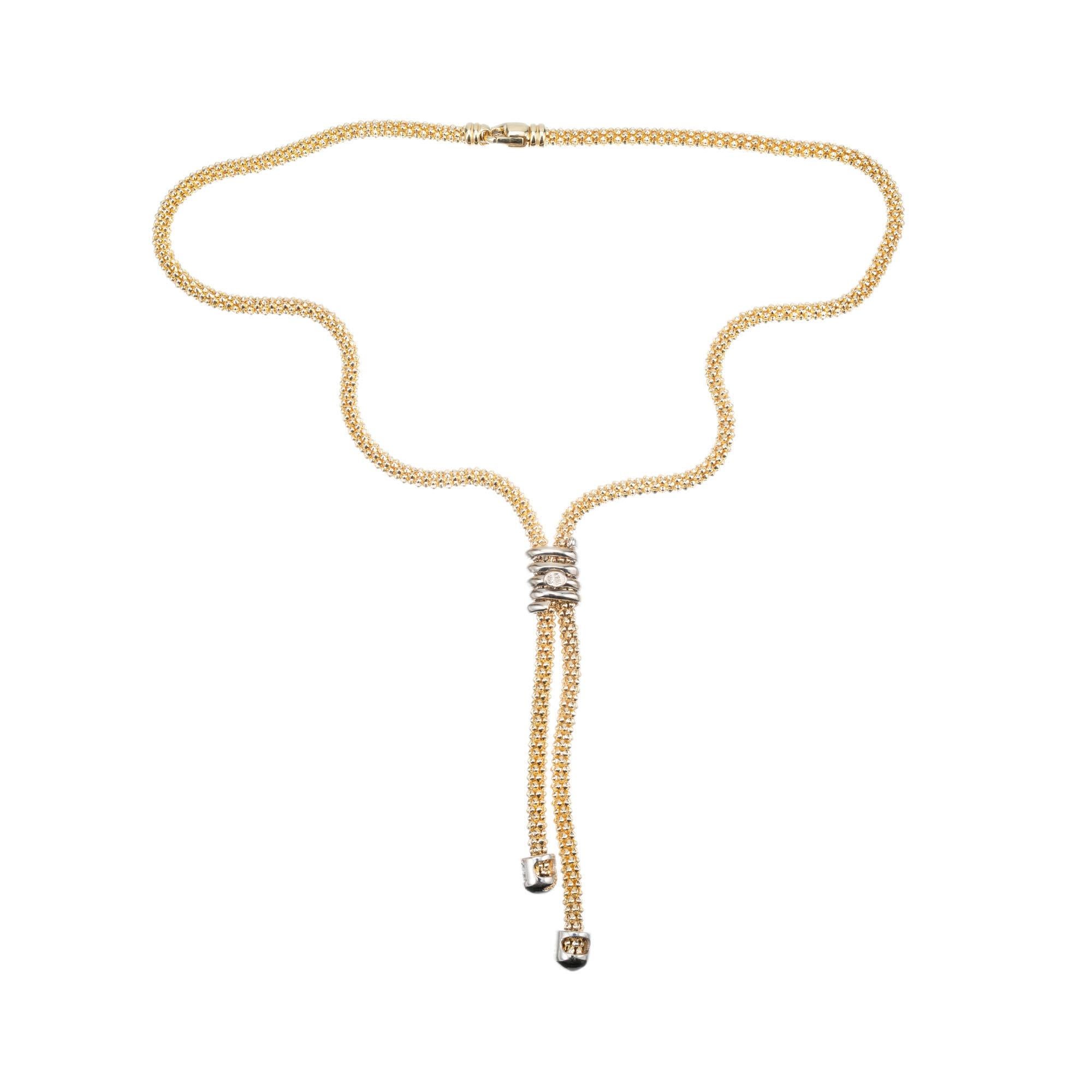 1980’s lariat style necklace in 14k yellow and white gold with .62 carat of diamond accents. Lobster catch. 18 inches in length. 

37 round diamonds, H-J SI approx. .62cts
14k yellow gold 
14k white gold 
Stamped: 14k
37.3 grams
Top to bottom: