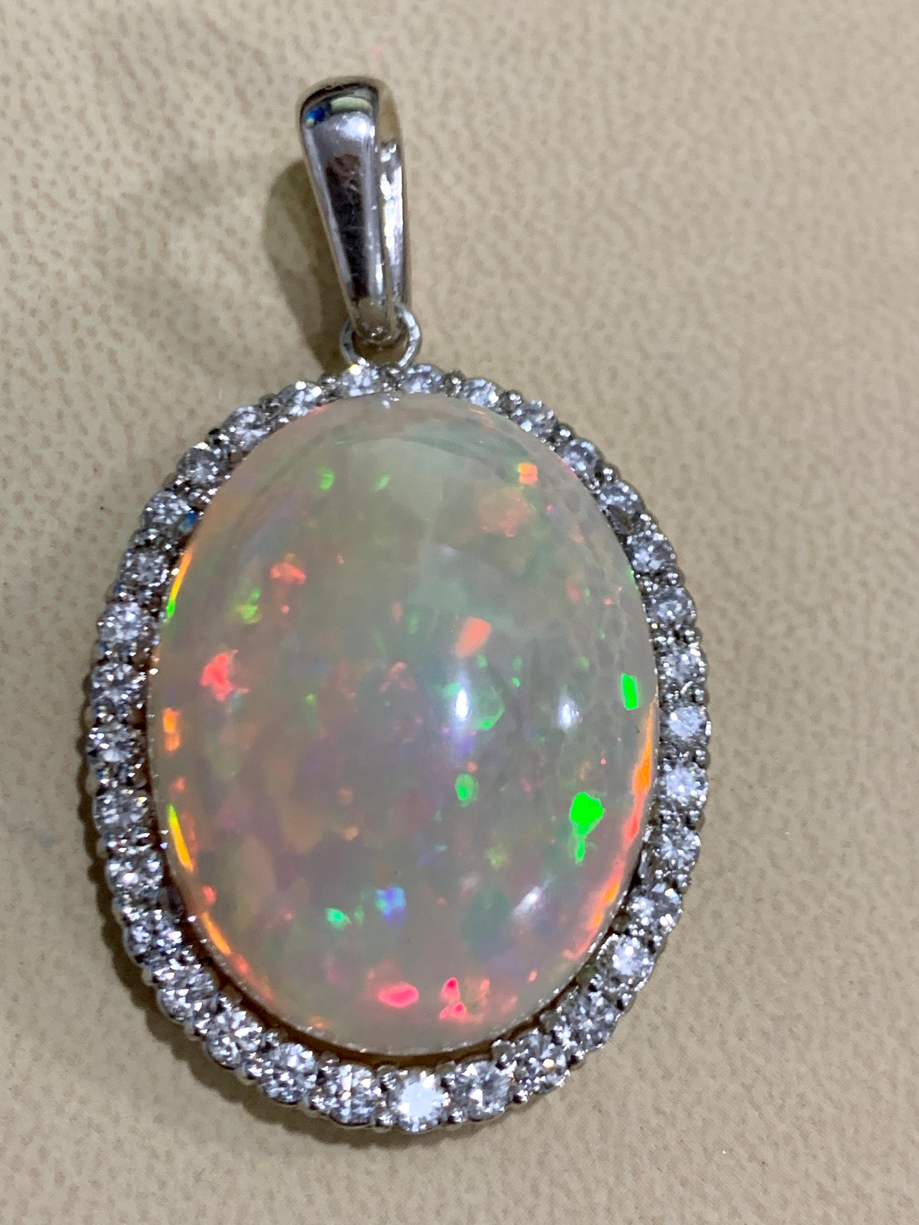 62 Carat Oval Ethiopian Opal &  3 carat Diamond Pendant / Necklace 14 Karat Gold Estate White Gold 
This spectacular Pendant Necklace consisting of a single Oval Shape Ethiopian Opal Approximately 62 Carat. The Opal is surrounded by approximately 3