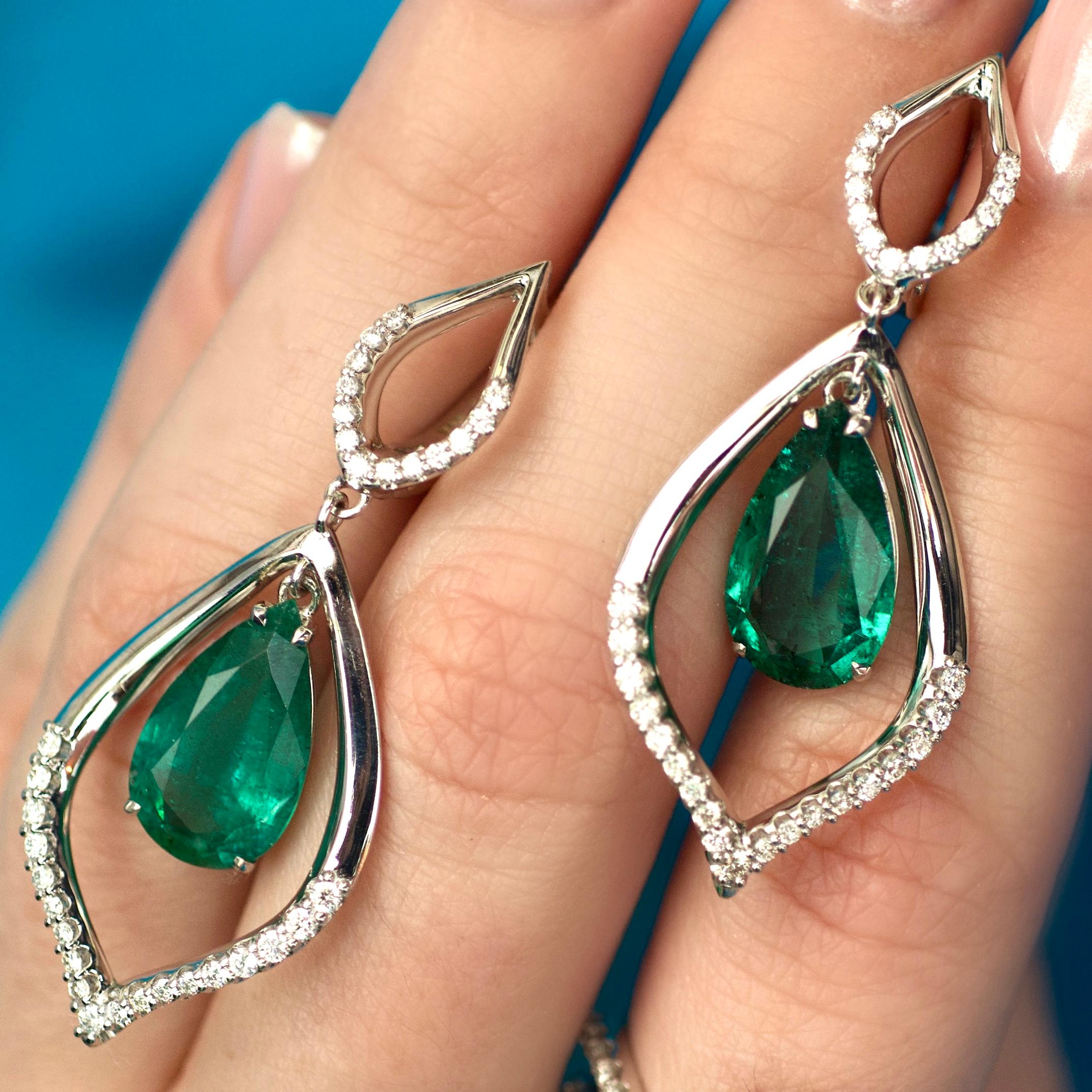 These earrings are very elegant, smooth and airy - white gold, some diamonds and two beautiful emeralds with rich green color from Zambia. 
With such earrings you could make any of your outfits looking fabulous. 
They will move with every step you