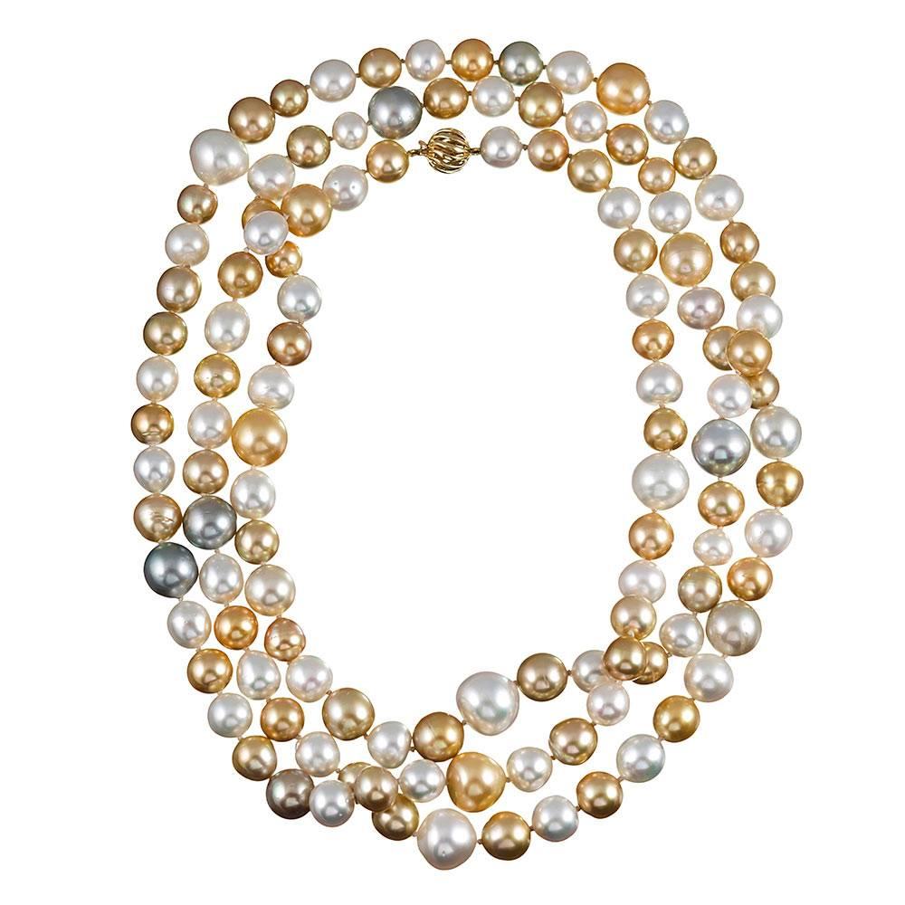 A gorgeous strand of 120 lustrous South Sea cultured pearls in hues of gold, white, silver, light grey and cream. The pearls range from 11.2 to 16.2 millimeters and are finished with a 14k yellow gold ball clasp.