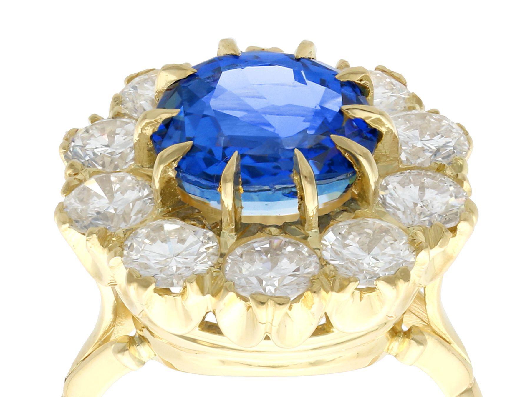 A stunning vintage 6.20 carat Ceylon sapphire and 3.20 carat diamond, 18 karat yellow and white gold cluster ring; part of our diverse gemstone jewelry and estate jewelry collections.

This stunning, fine and impressive vintage sapphire ring has
