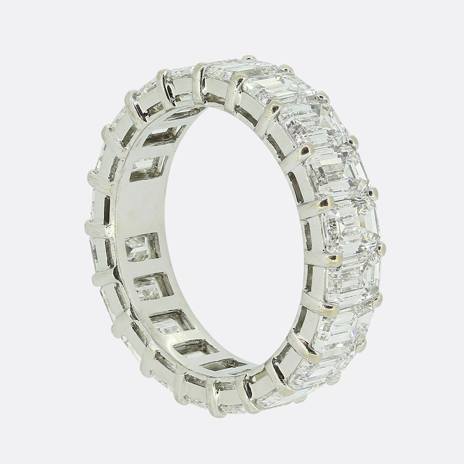 Here we have a gorgeous eternity ring featuring a continuous row of bright white emerald-cut diamonds. Each stone has been meticulously claw set in platinum to creating a seamless band of brilliance. The diamonds are uniform in size, enhancing the