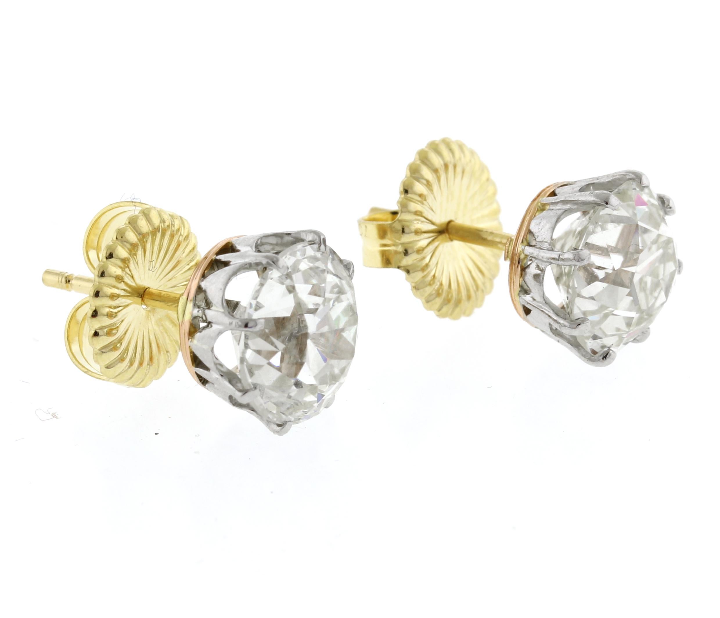 Experience timeless elegance with these exquisite diamond stud earrings, boasting a remarkable total carat weight of 6.21 carats. Crafted with the utmost precision, these earrings feature settings of 18-karat gold and platinum, merging tradition and