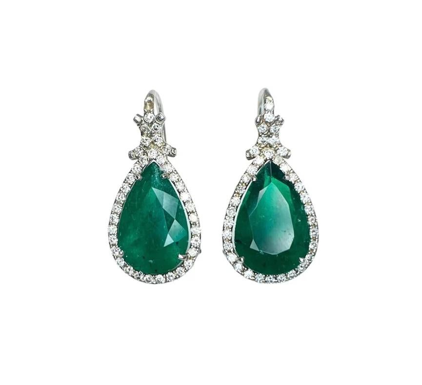 These beautiful emerald & diamond earrings feature 2 emeralds weighing 6.22 cts and diamonds weighing 0.74 cts set in 18k white gold.