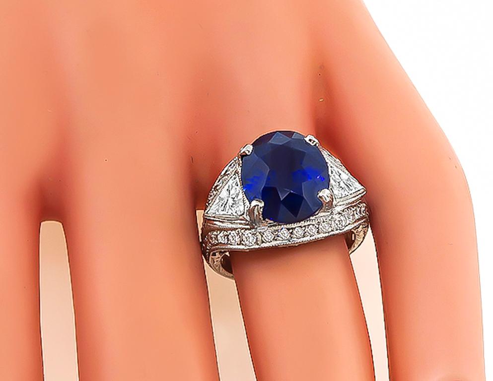 This is an amazing platinum engagement ring. The ring is centered with a lovely oval cut sapphire that weighs 6.22ct. The sapphire is accentuated by sparkling trilliant and round cut diamonds that weigh approximately 0.70ct and 1.00ct respectively.