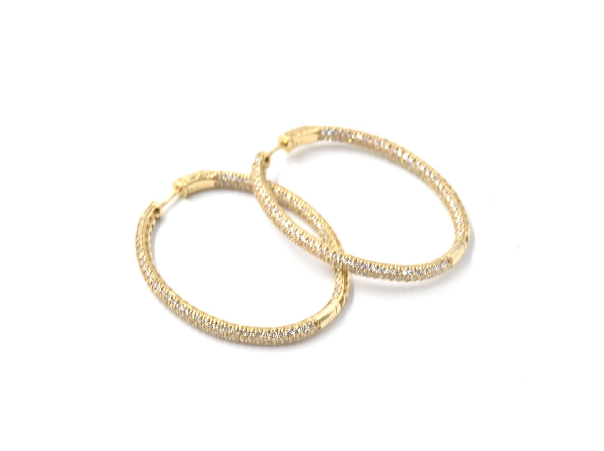 Designer: custom design
Material: 14k yellow gold
Diamonds: 400 round brilliant cut diamonds = 6.23 carat total weight
Color: G
Clarity: VS2
Dimensions: each earring is 2-inch long and 1 1/2-inch wide
Fastenings: snap closures
Weight: 20.38
