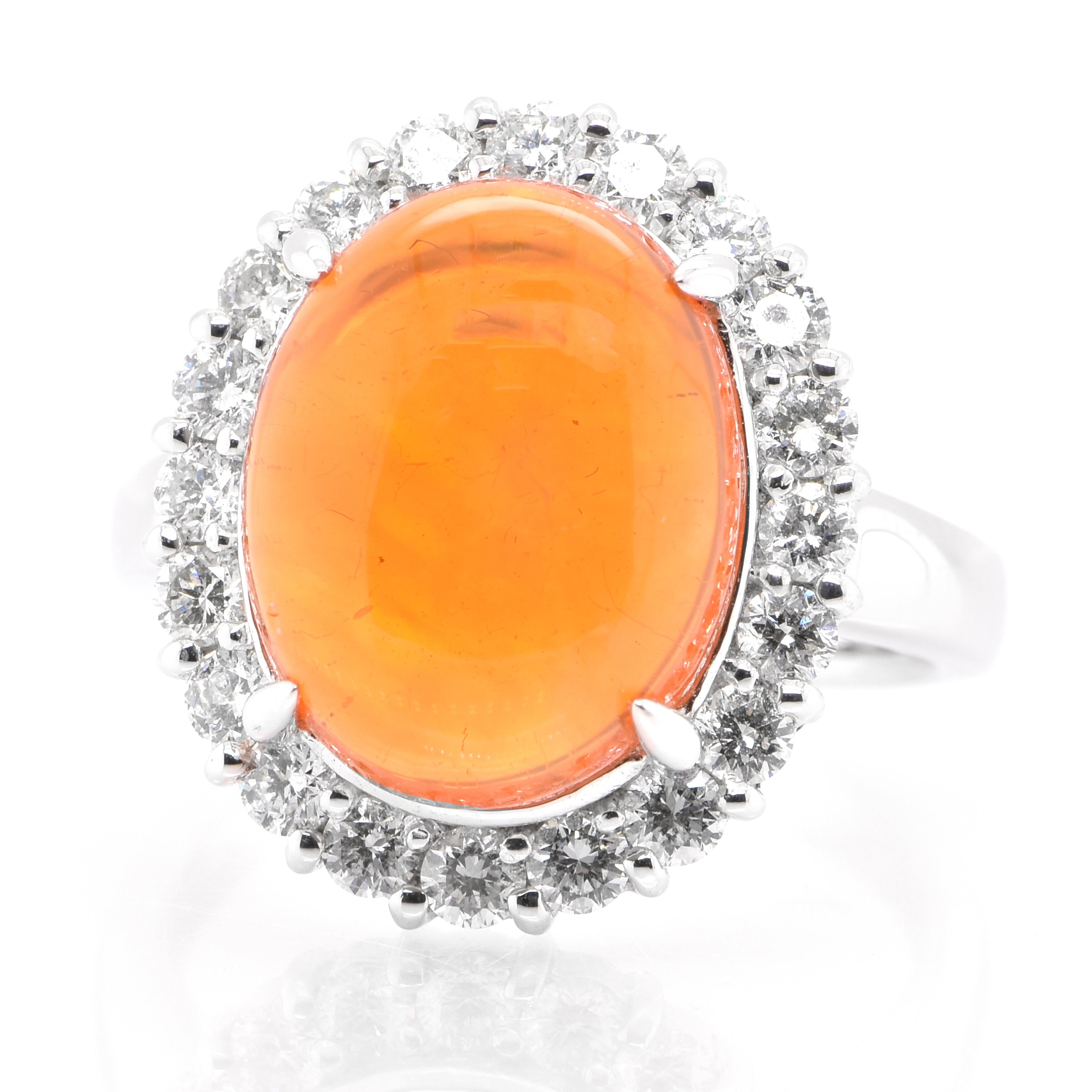 A beautiful ring featuring a 6.23 Carat Natural Mexican Fire Opal and 1.00 Carats of Diamond Accents set in Platinum. Opals are known for exhibiting flashes of rainbow colors known as 