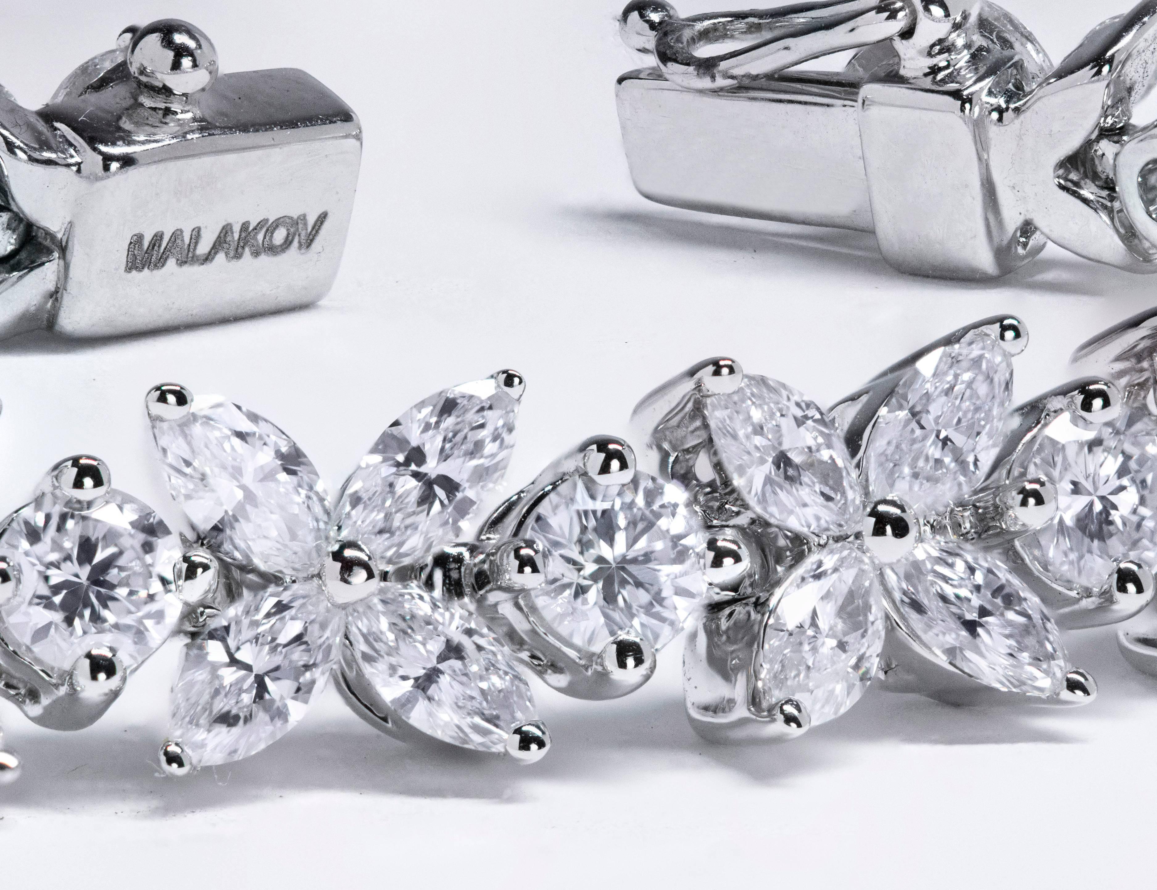 This bracelet features marquee cut diamonds set in a flower-like setting with a brilliant round diamond set after each link. Total weight of the marquise cut and round cut diamonds are 4.24 carats and 1.99 carats respectively. Made in 18k white