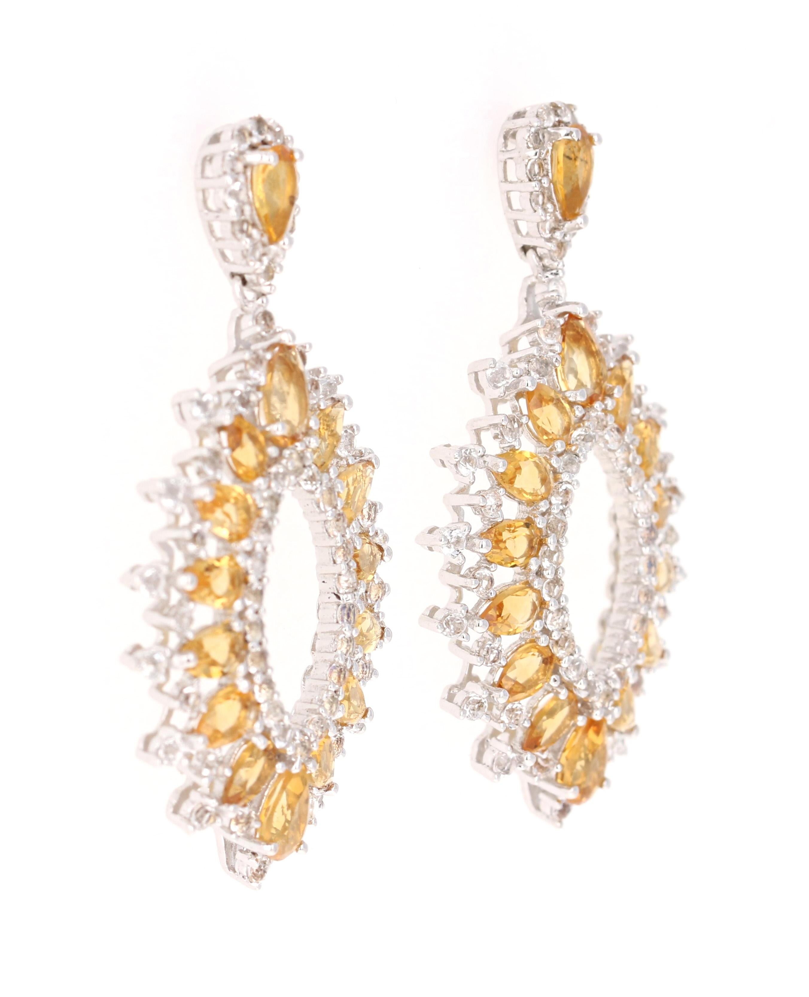 Stunning Chandelier Dangle Earrings 

These earrings have 6.25 Carats of Citrines and White Topaz.

They are beautifully curated in 925 Silver weighing approximately 11.0 grams 

They are 1.75 inches long. 
