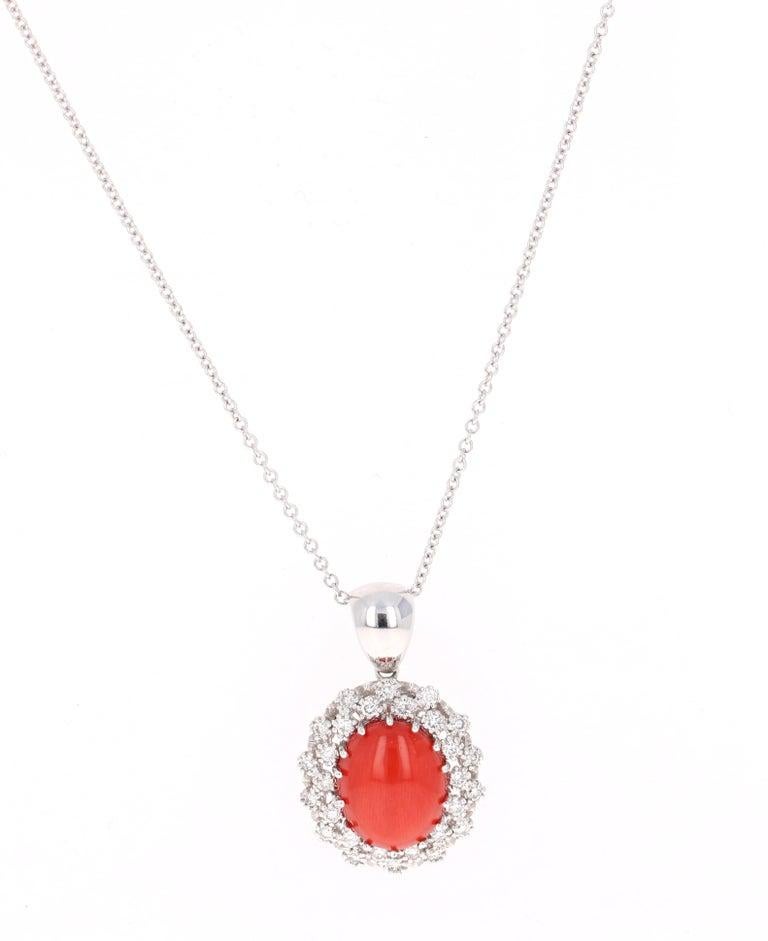 

This one of a kind beauty has a magnificent 5.46 Carat Oval Cut Coral. It is surrounded by 28 Round Cut Diamonds that weigh 0.79 Carats.  The total carat weight of the pendant is 6.25 carats.

The pendant is made in 14 Karat White Gold and weighs