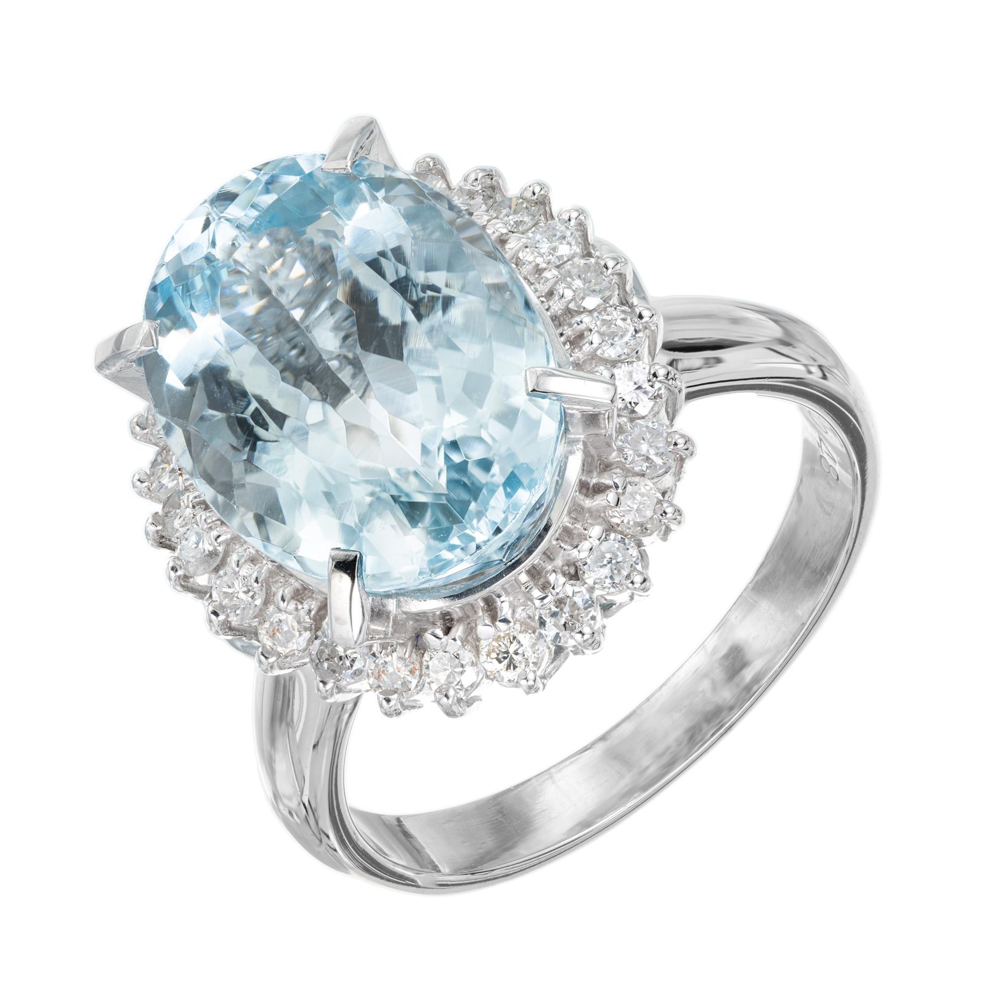 Mid-Century Bright blue clear oval aqua and diamond cocktail ring. This spectacular large 6.25ct oval aquamarine center stone is mounted in a handmade platinum setting with a 26 round brilliant cut diamond halo.  Circa 1950-1960.

1 oval blue aqua,