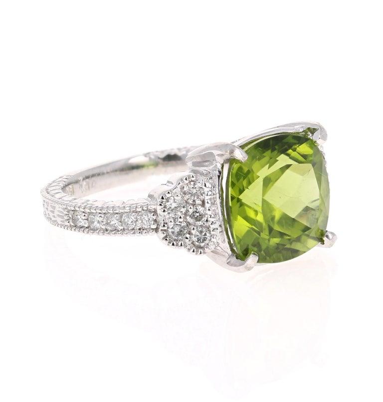Bright, Beautiful and Bling! 

This ring has a 5.89 Carat Cushion Cut Peridot and has 20 Round Cut Diamonds that weigh 0.36 Carats. The total carat weight of the ring is 6.25 Carats. 

It is set in 14 Karat White Gold and weighs approximate 6.6