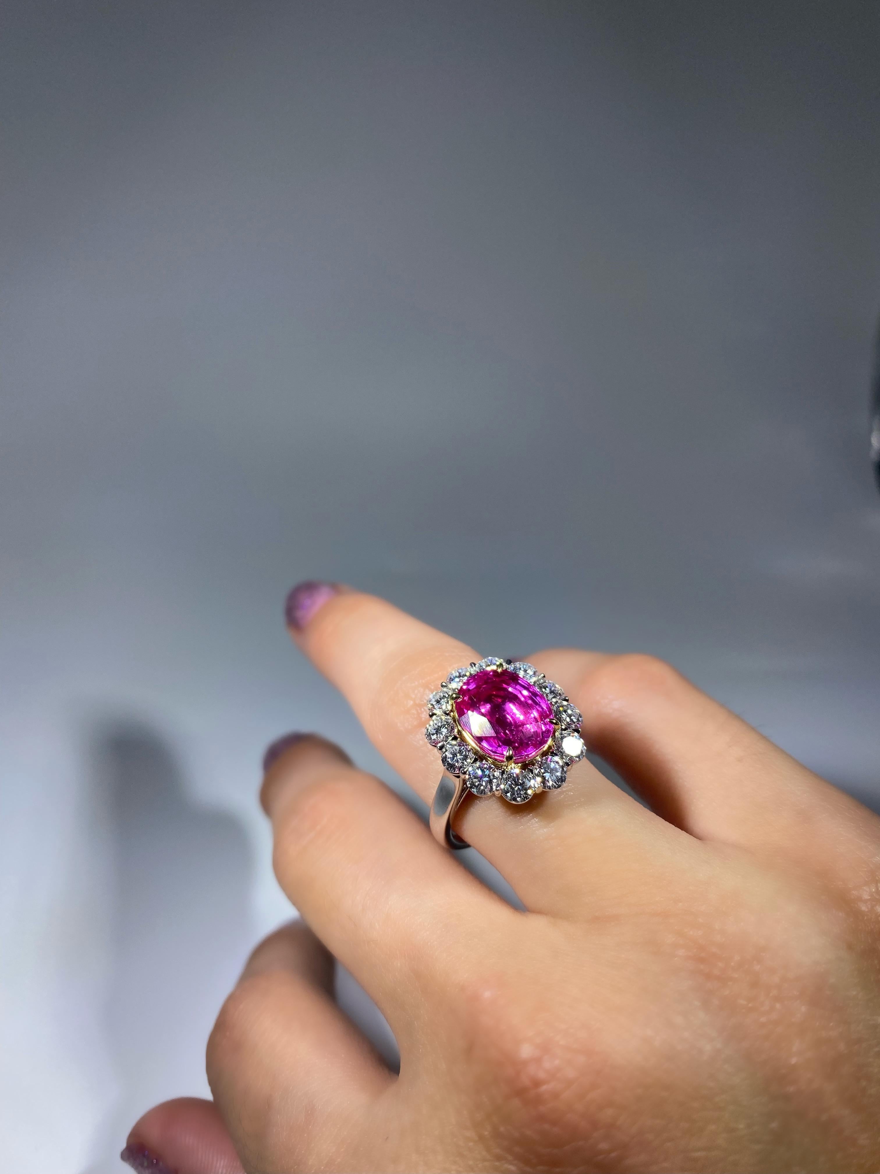 6.25 Carat Natural Pink Sapphire (Burmese Origin), is encapsulated in a 1.72-carat diamond halo, made in 18K Gold. 

Gemstone Details
Pink Sapphire Details 
Shape Oval
Color Intense Pink with Violet Hues
Origin Burma
Treatment Unheated 
Size	6.25