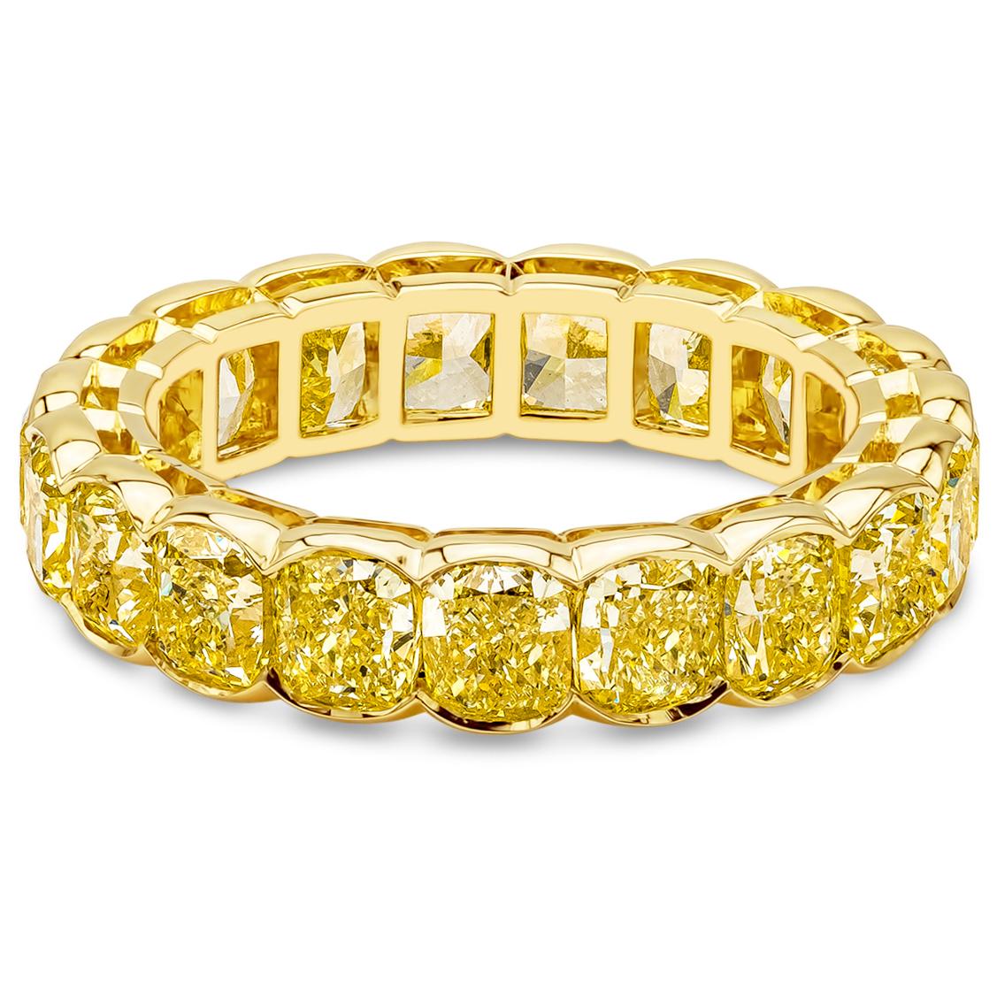 A color-rich eternity wedding band ring design showcasing a row of cushion cut fancy intense yellow diamonds weighing 6.40 carats total, VS in Clarity. Set in a chic half-bezel basket setting, Made with 18K Yellow Gold, Size 6.5 US resizable upon
